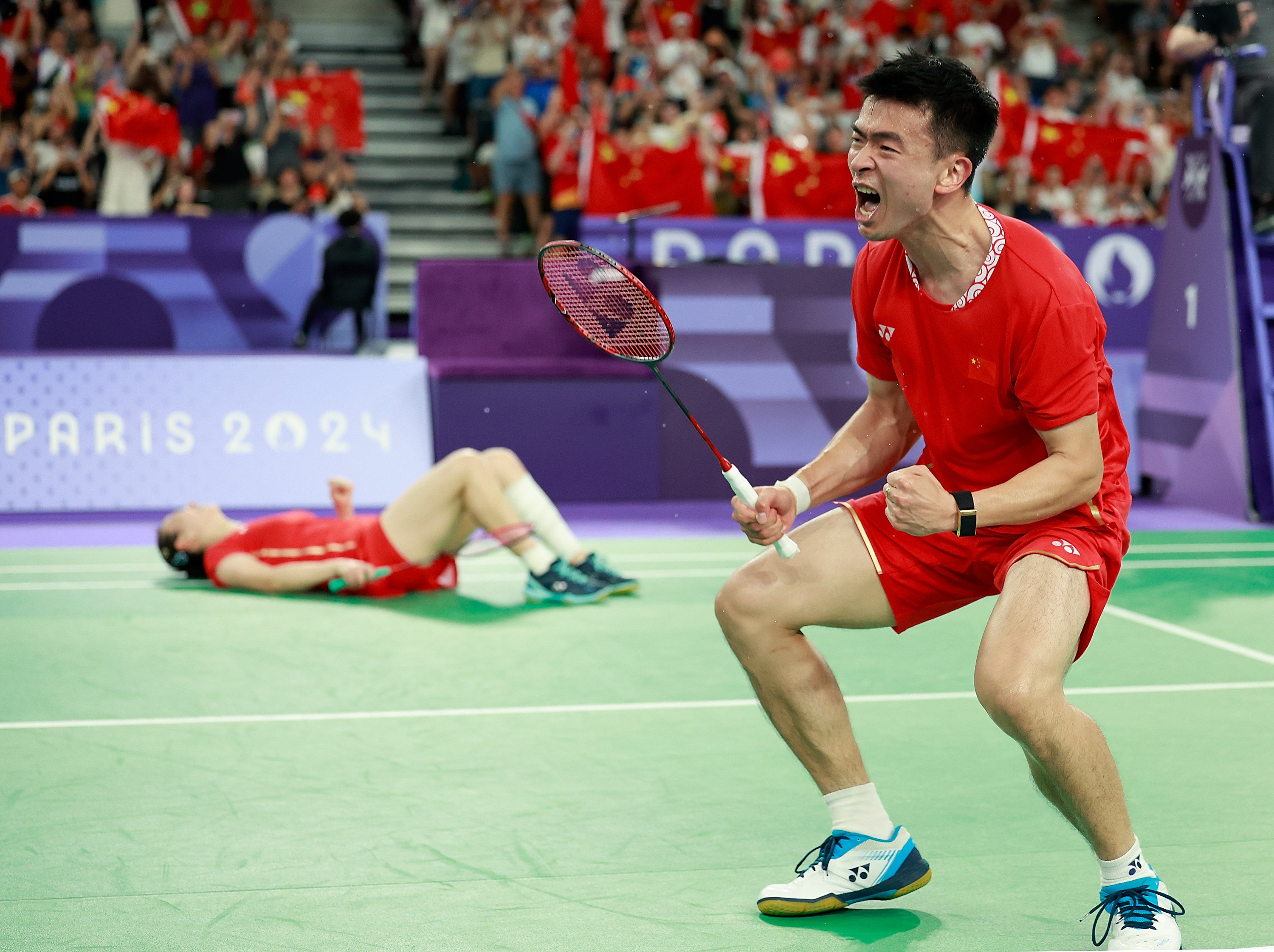 Zheng Siwei (right) and playing partner Huang Yaqiong celebrate winning gold at the Paris Olympics. Photo: Xinhua