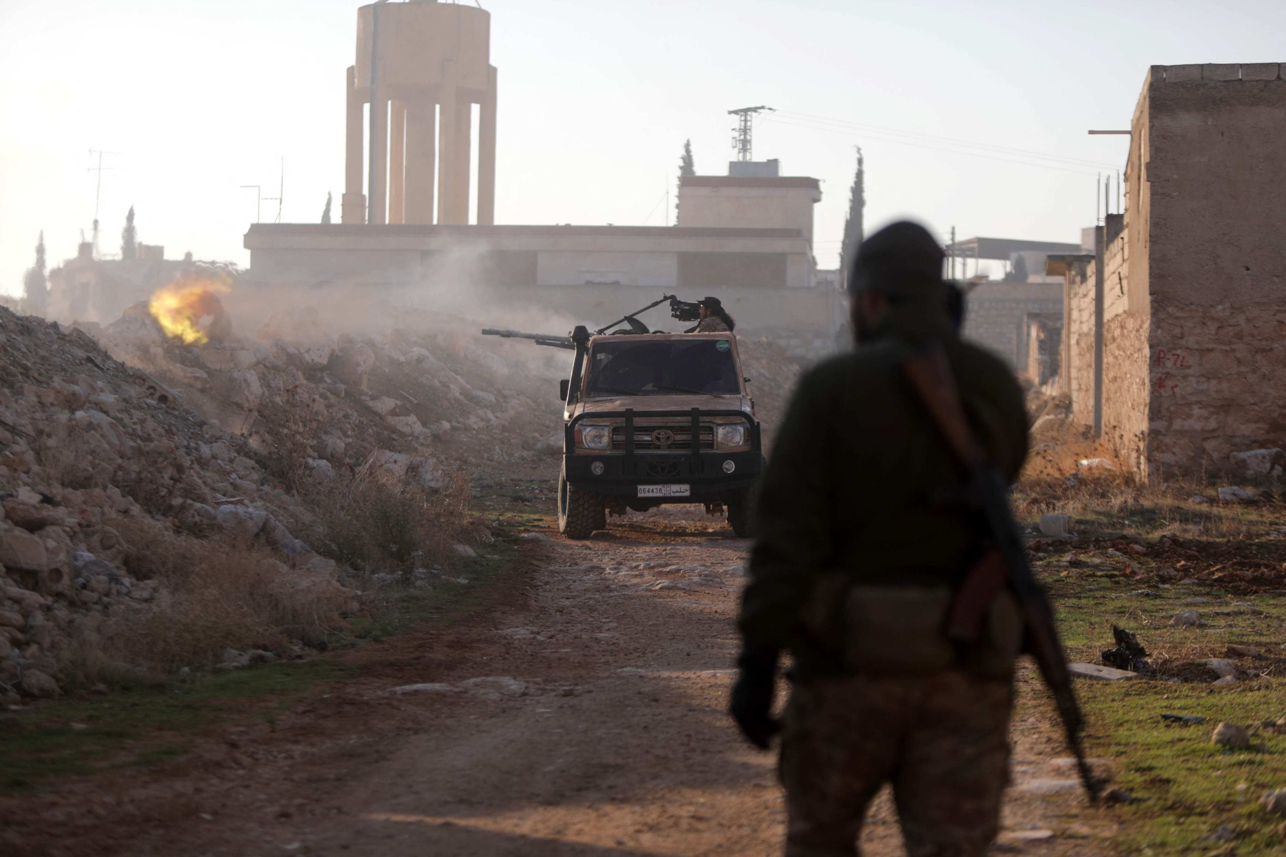 Fighters fire at Syrian Army troops in the Rashidin district on the outskirts of Aleppo on Friday. Photo: AFP