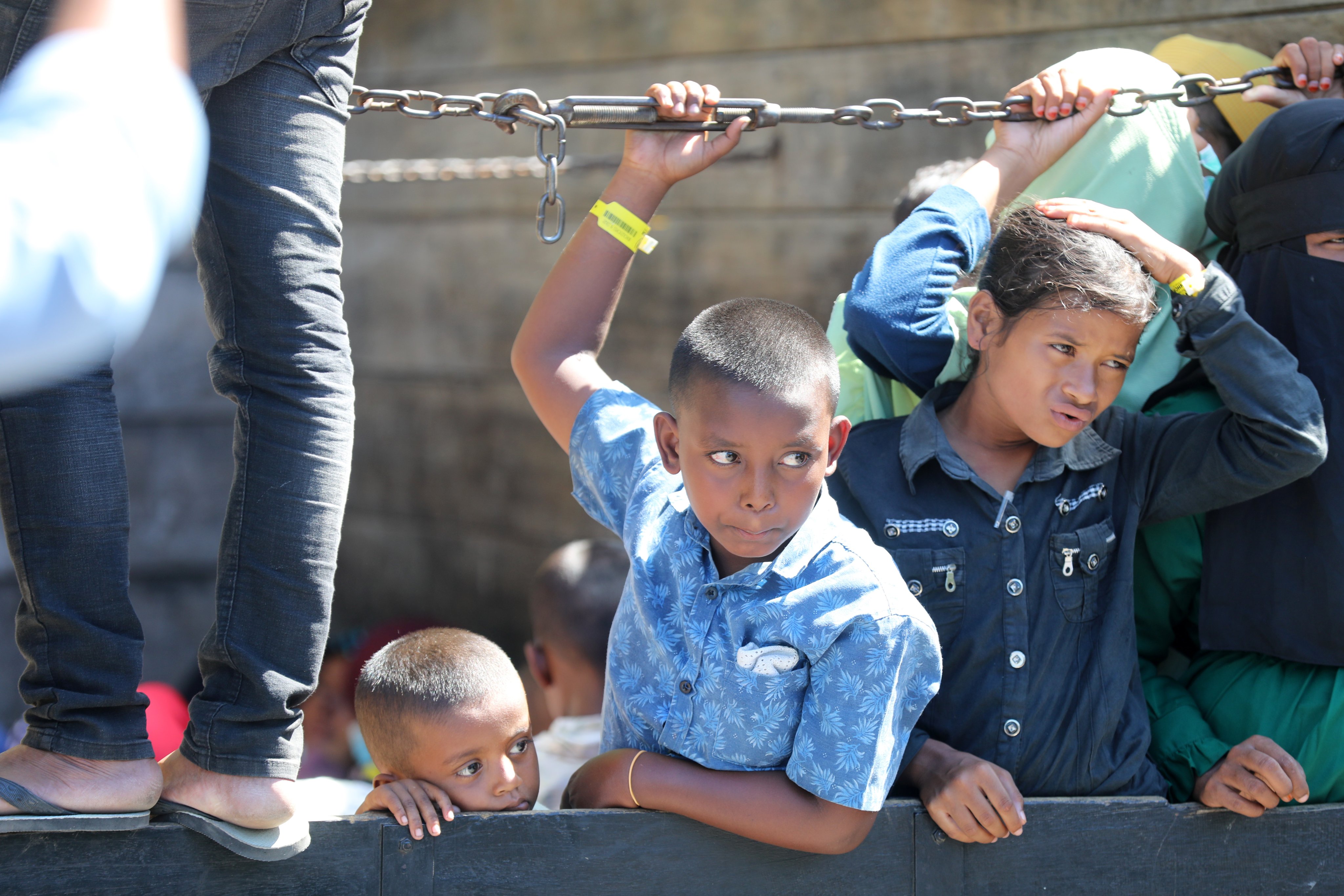 Rohingya refugee children wait to disembark a truck after being forcibly relocated from South Aceh to the capital city of Aceh province in Banda Aceh, Indonesia, on November 7. Photo: EPA-EFE