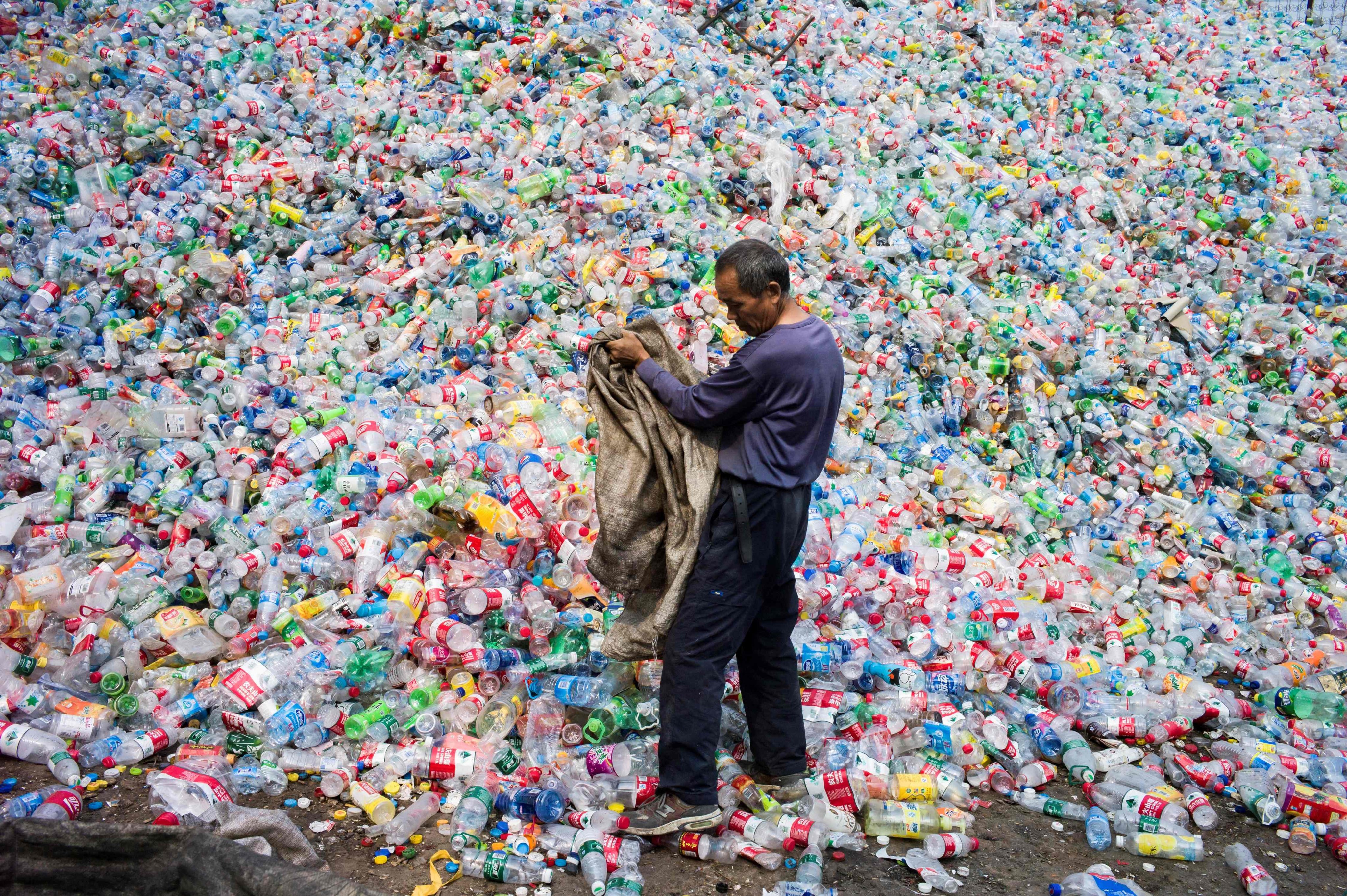 A Chinese labourer sorts out plastic bottles for recycling in Dong Xiao Kou village on the outskirts of Beijing. Photo: AFP