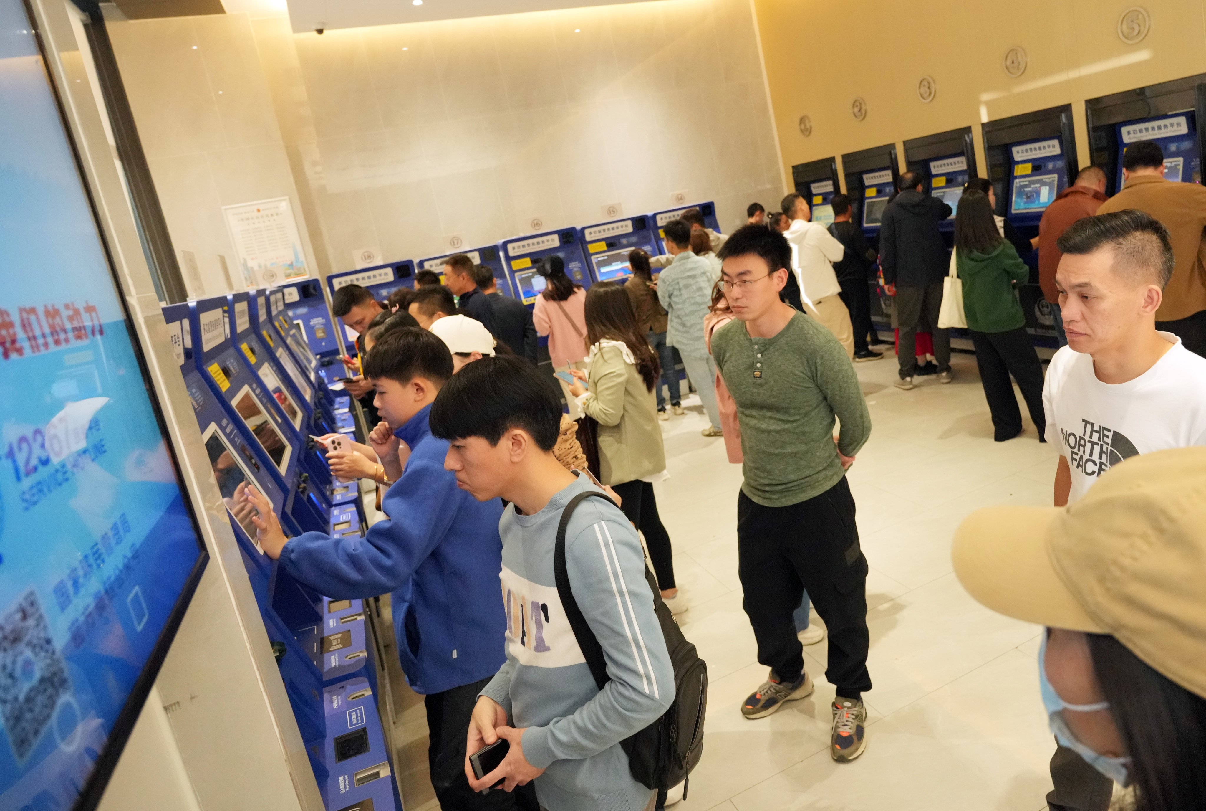 At the self-service centres, Shenzhen residents were seen spending around 10 to 15 minutes processing the visas via a machine. Photo: May Tse