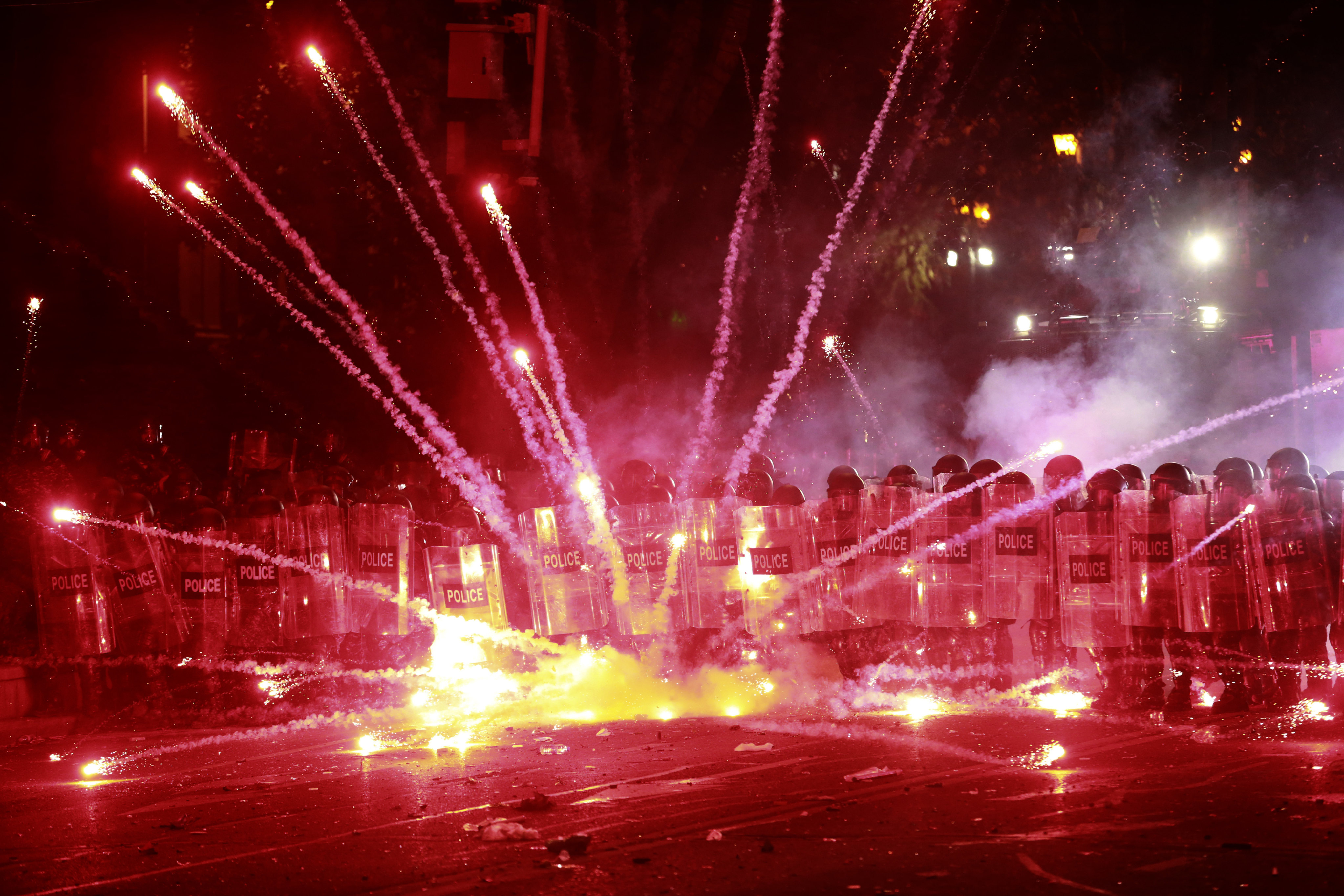 Demonstrators use firecrackers against police in Tbilisi, Georgia. Photo: AP