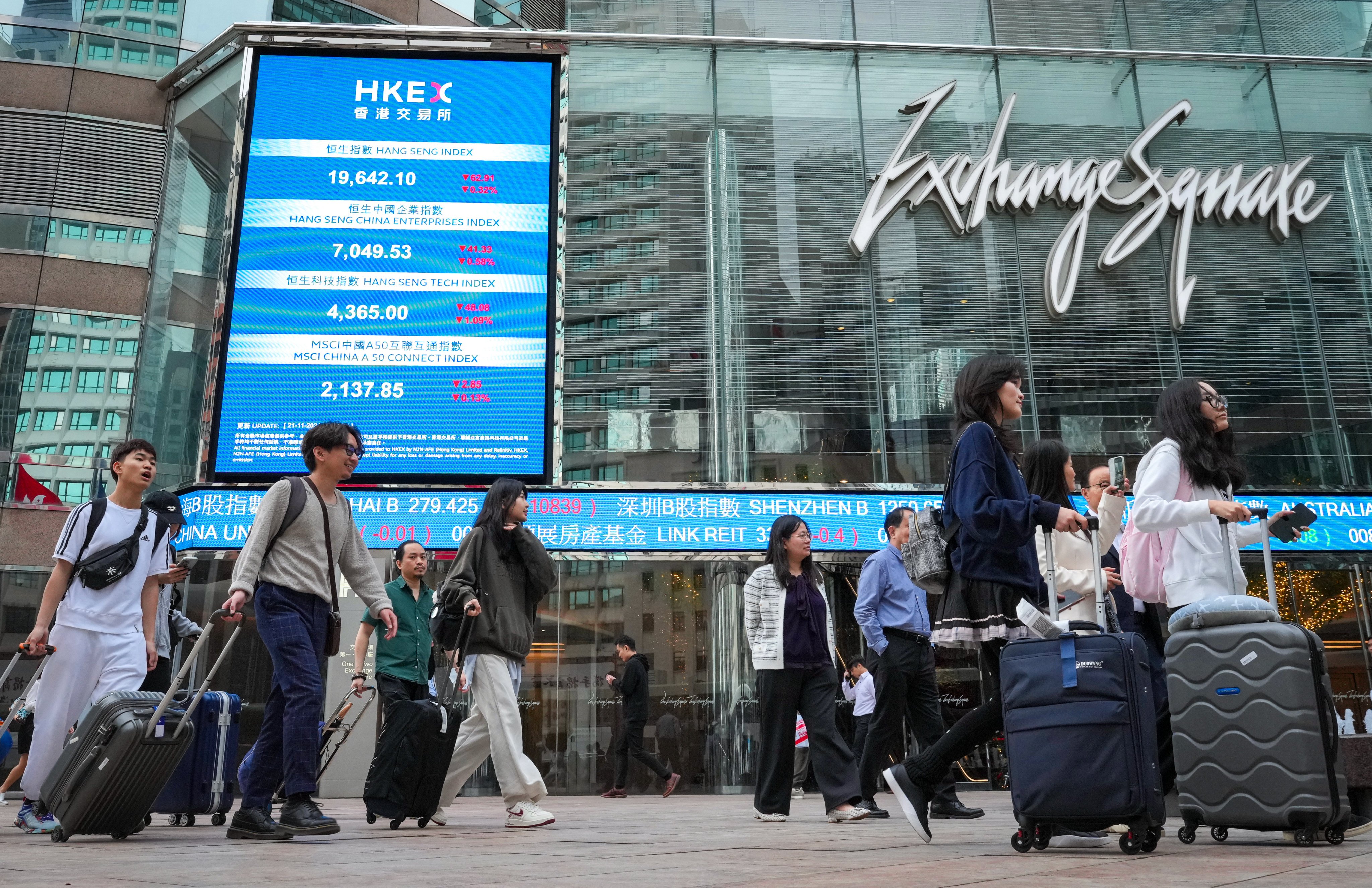 People walk by the Hong Kong stock exchange in Central. Photo: May Tse