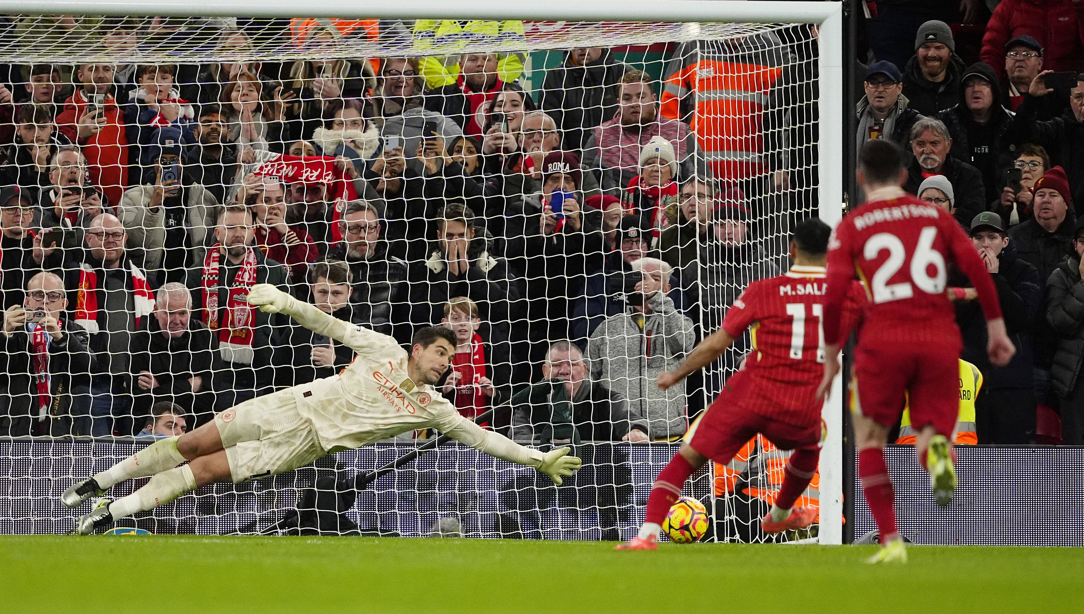 Liverpool’s Mohamed Salah scores from the penalty spot past Manchester City goalkeeper Stefan Ortega. Photo: AP