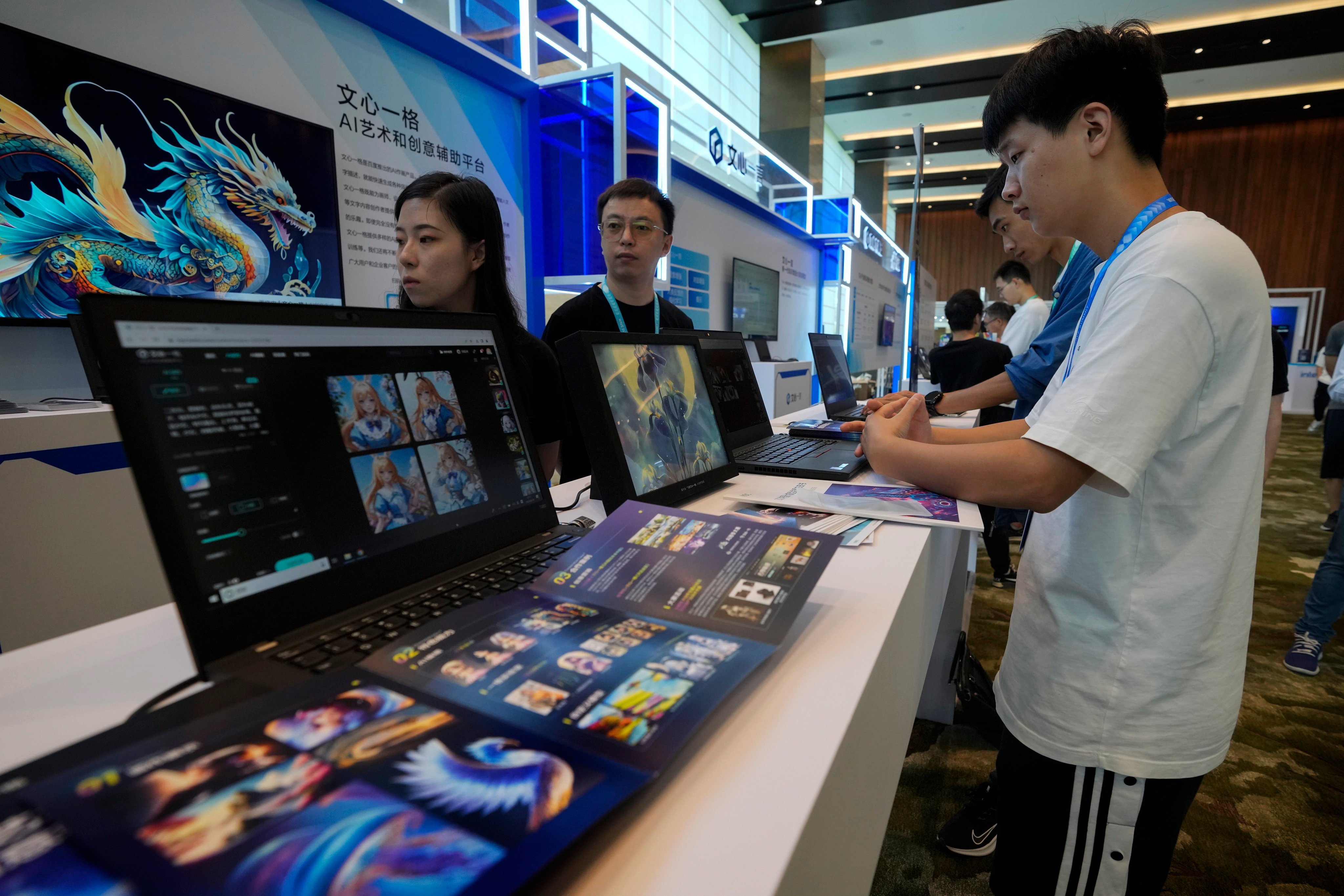 Visitors try out Ernie Bot during the Wave Summit in Beijing, August 16, 2023. Photo: AP