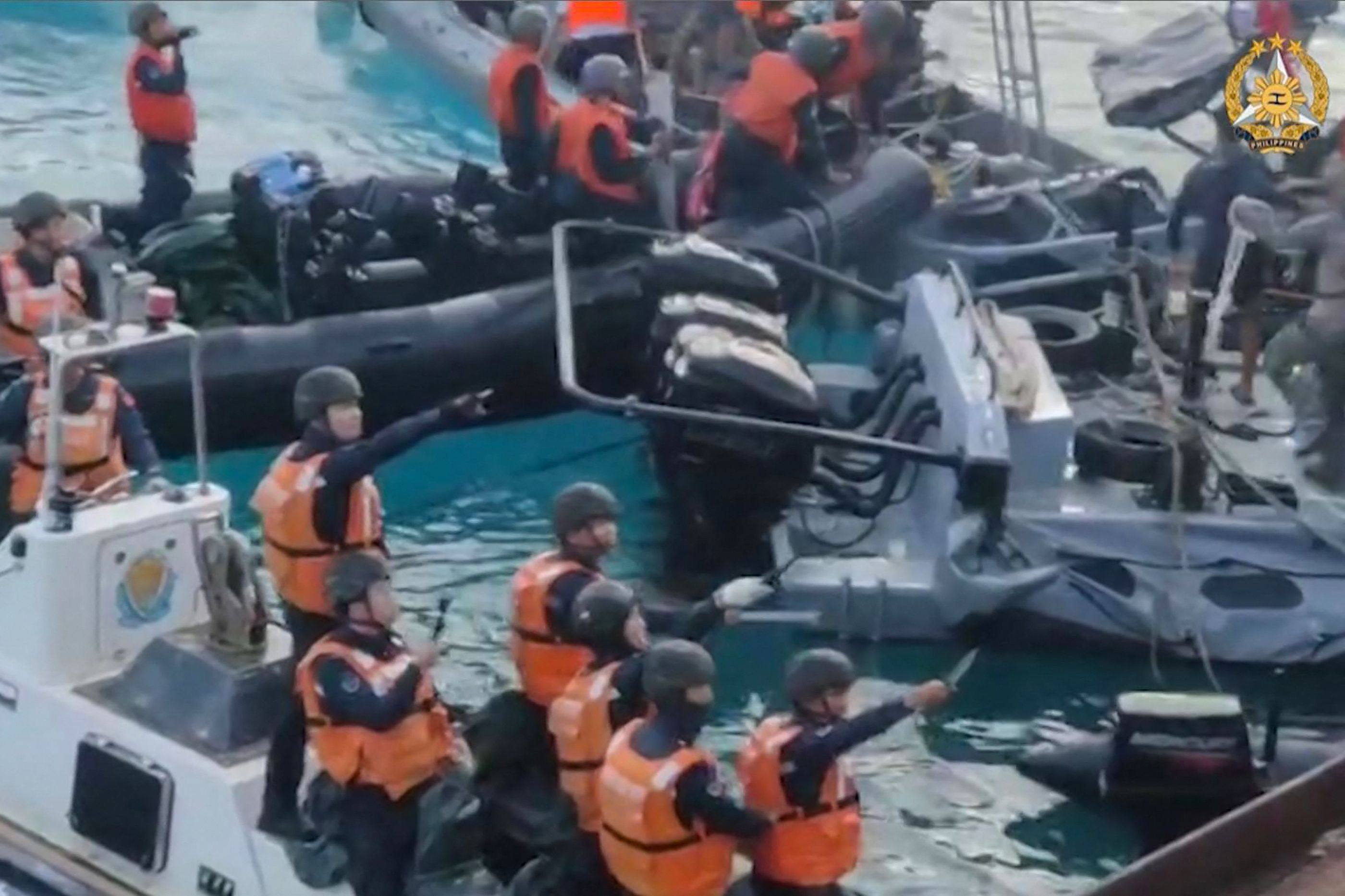 Chinese coastguard personnel appearing to wield bladed weapons during a clash in the Second Thomas Shoal in the South China Sea. Photo: AFP