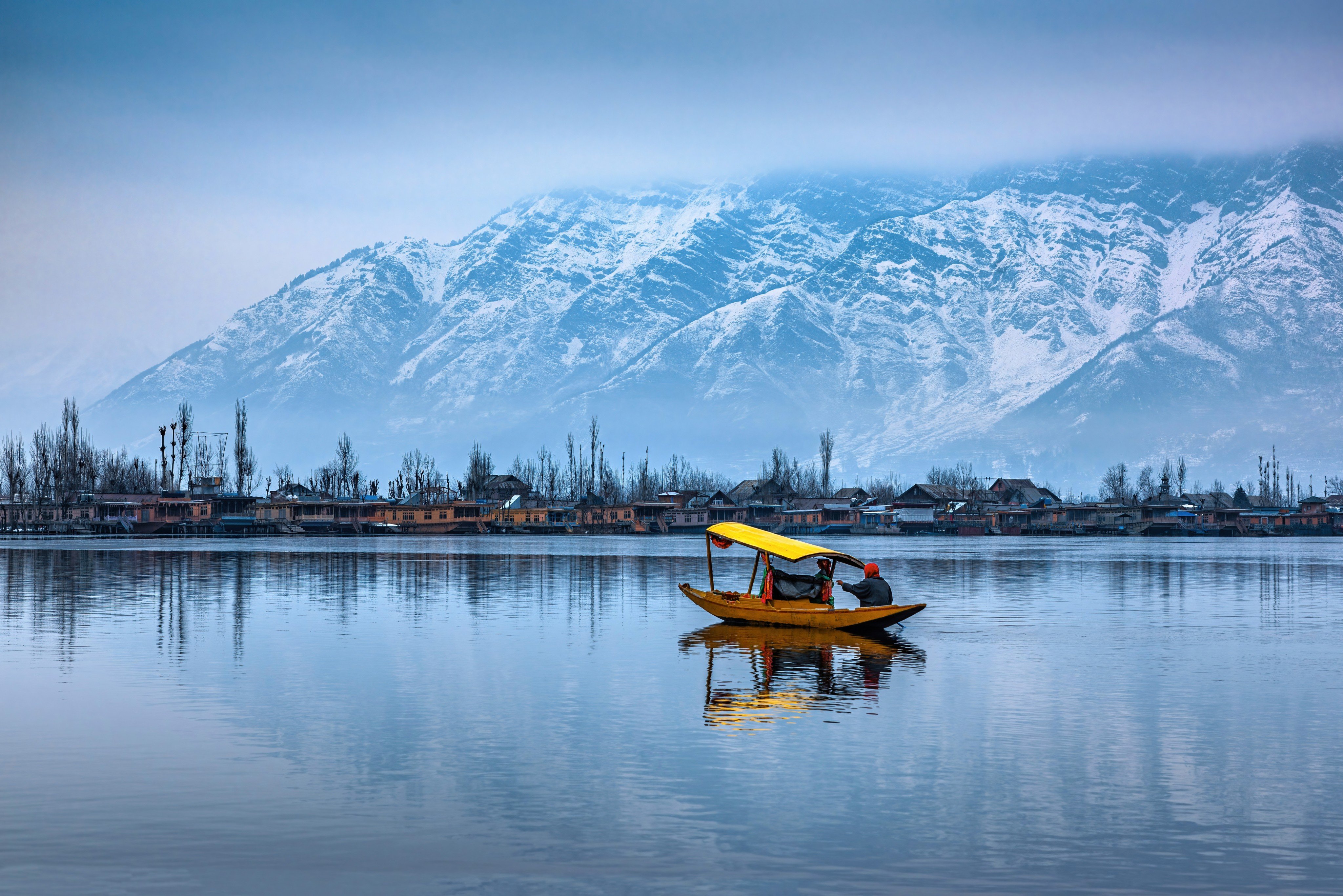 A view of Dal Lake in winter, and the beautiful mountain range in the background in the city of Srinagar, Kashmir, India.