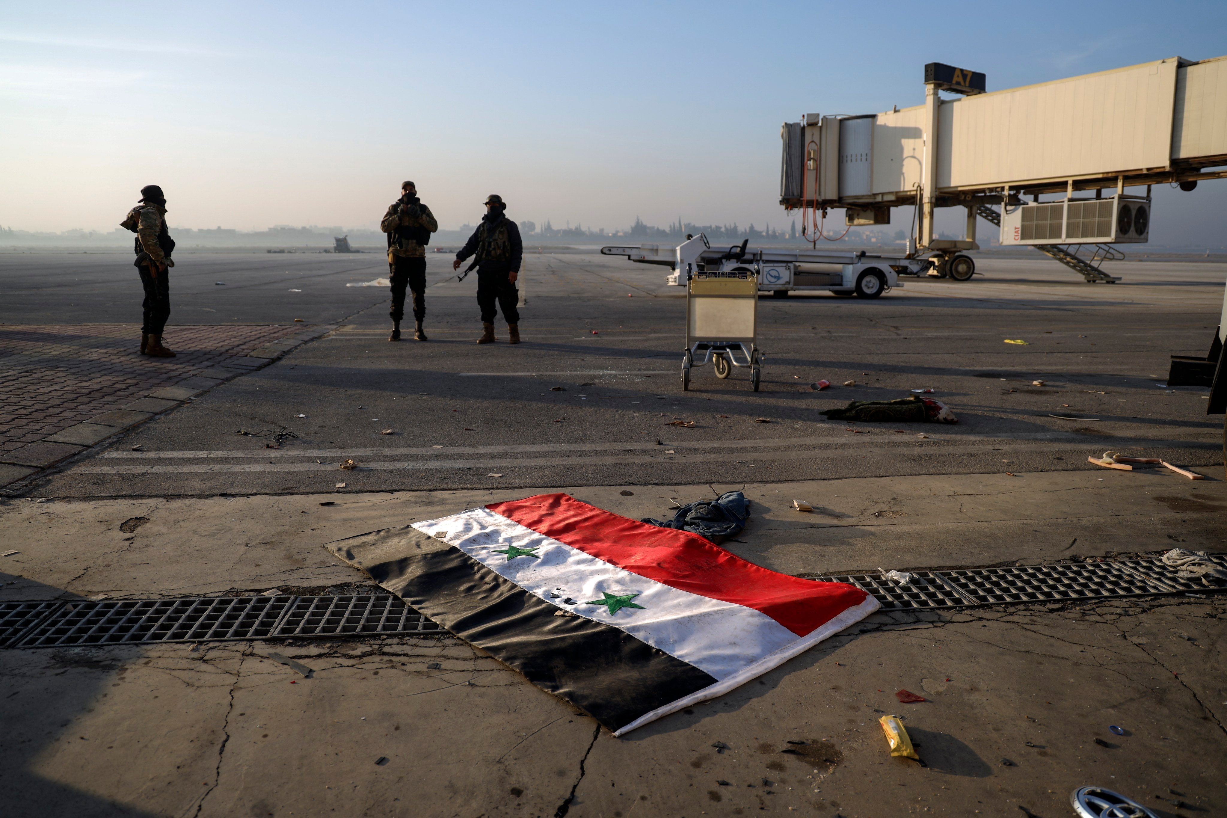 A Syrian flag lies on the tarmac of the Aleppo international airport, on December 2. Photo: AP