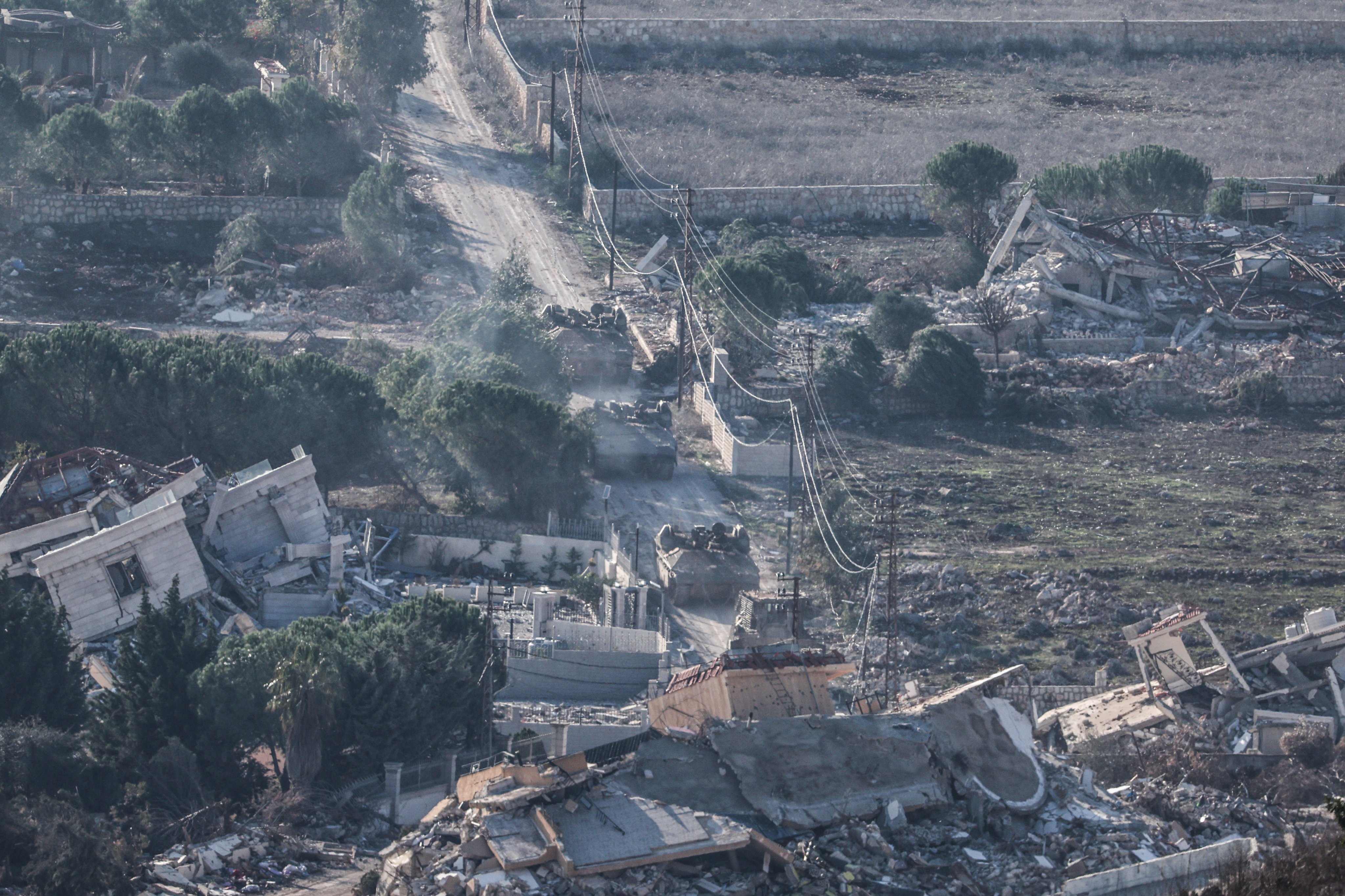 Israeli troops move between destroyed houses, in the south Lebanon village of Meiss El-Jabal, as they leave Lebanon on their way back into Israel. Photo: EPA-EFE