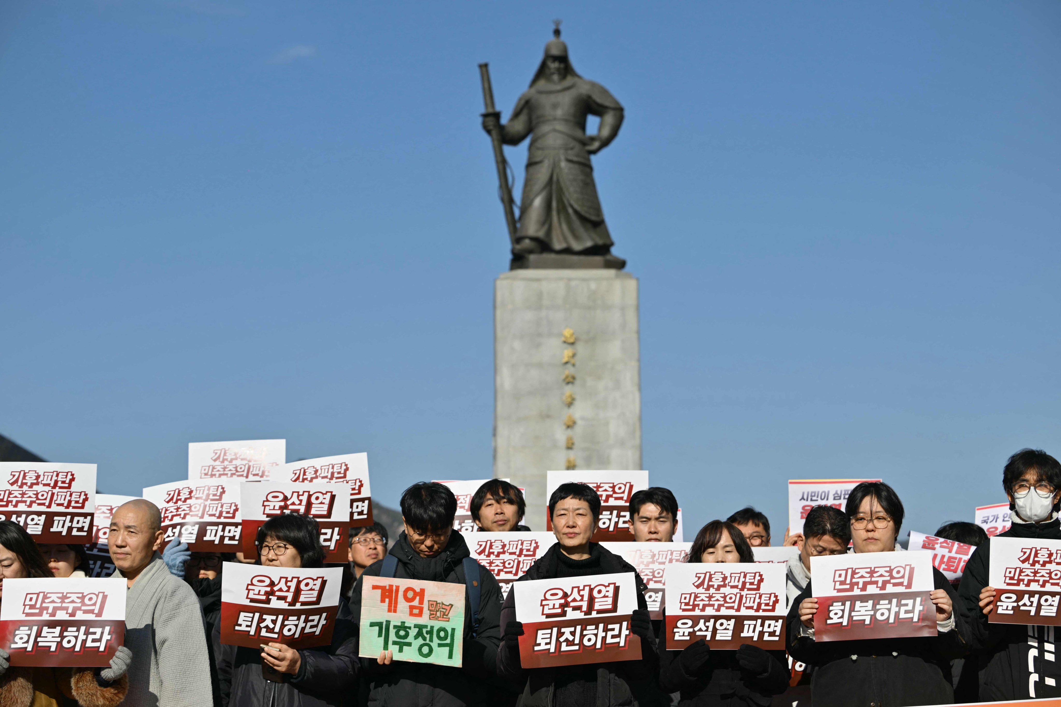 Protesters hold placards calling for the resignation of South Korea President Yoon Suk-yeol at Gwanghwamun Square in Seoul on Wednesday. Photo: AFP