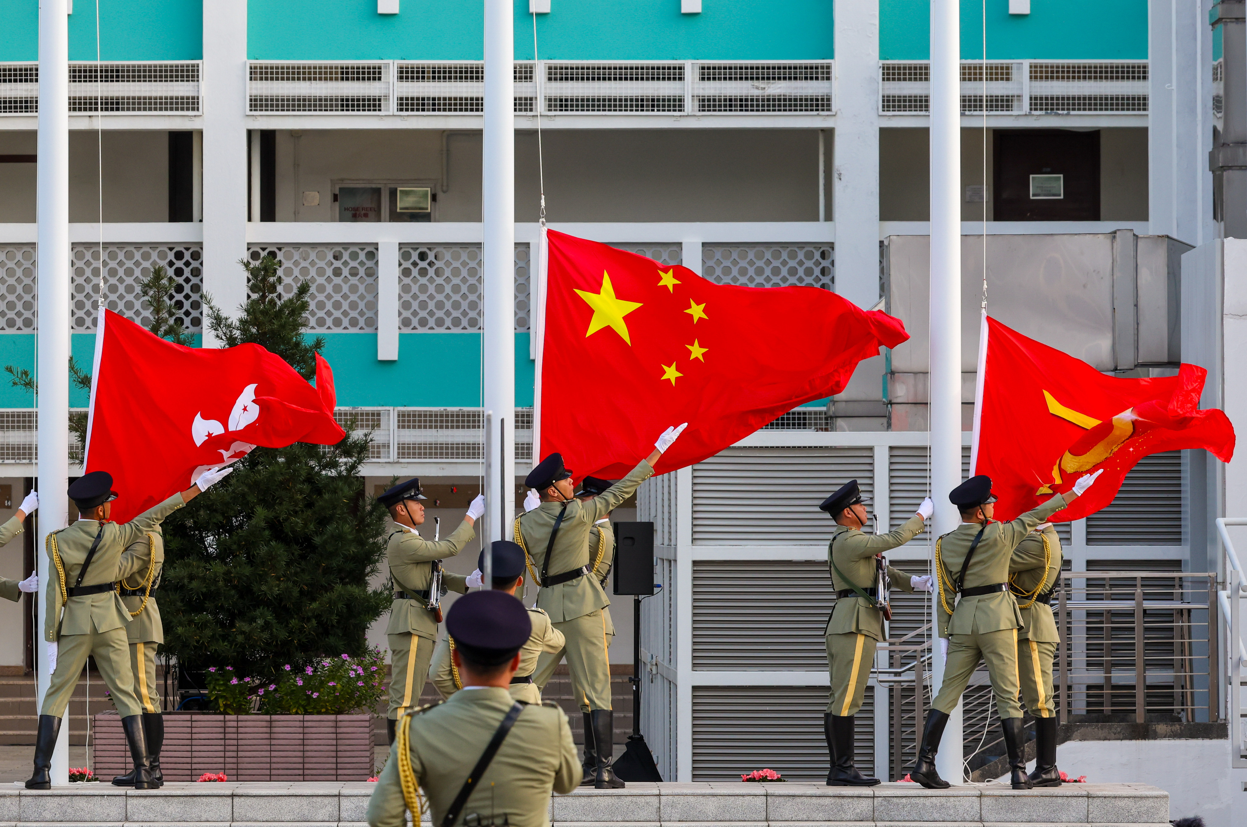 A flag-raising ceremony takes place to mark Constitution Day. Photo: Dickson Lee