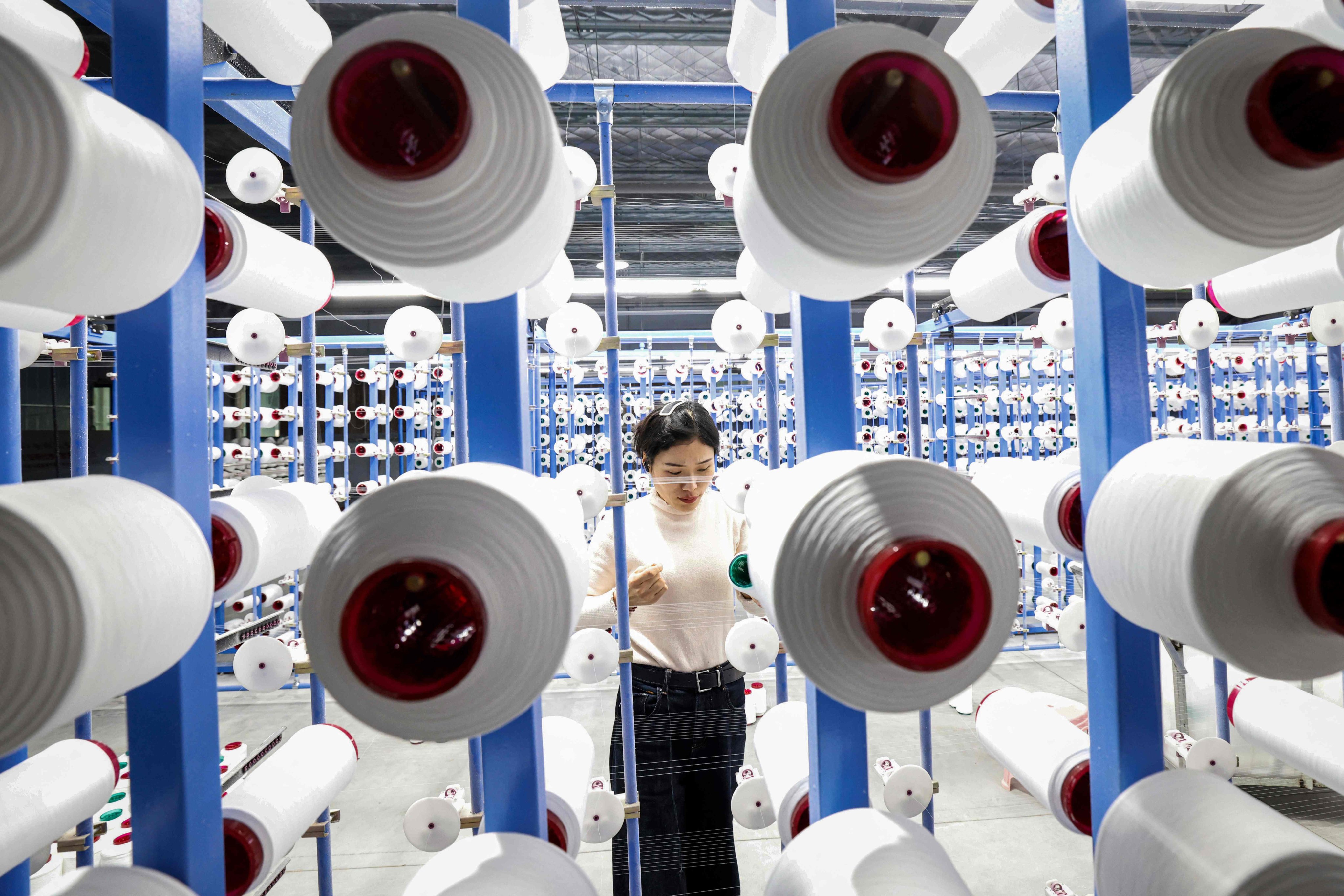 An employee works at a textile factory in Sihong in eastern China’s Jiangsu province. Photo: AFP