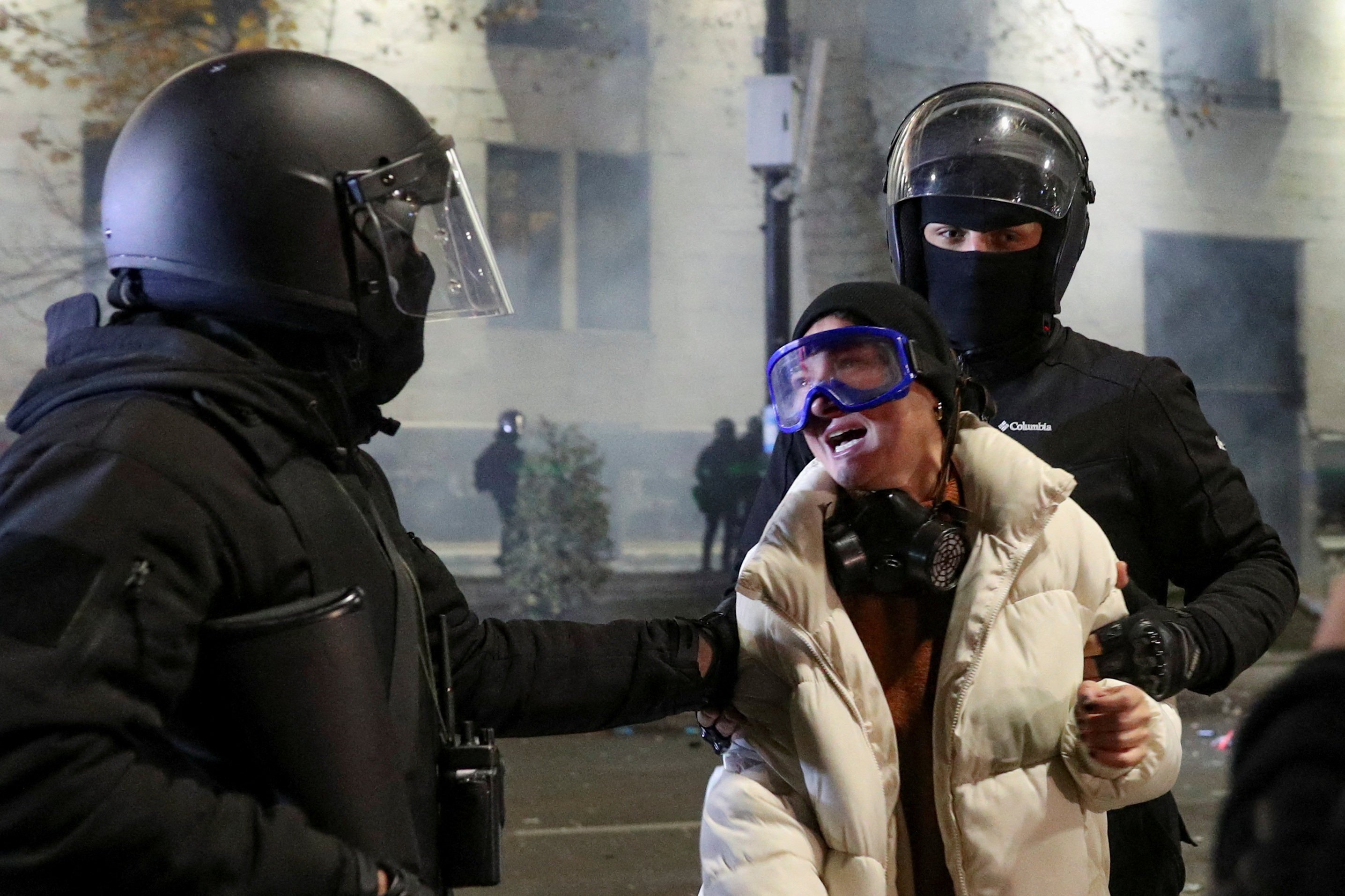 Law enforcement officers hold a person during protests in Tbilisi, Georgia on Tuesday. Photo: Reuters