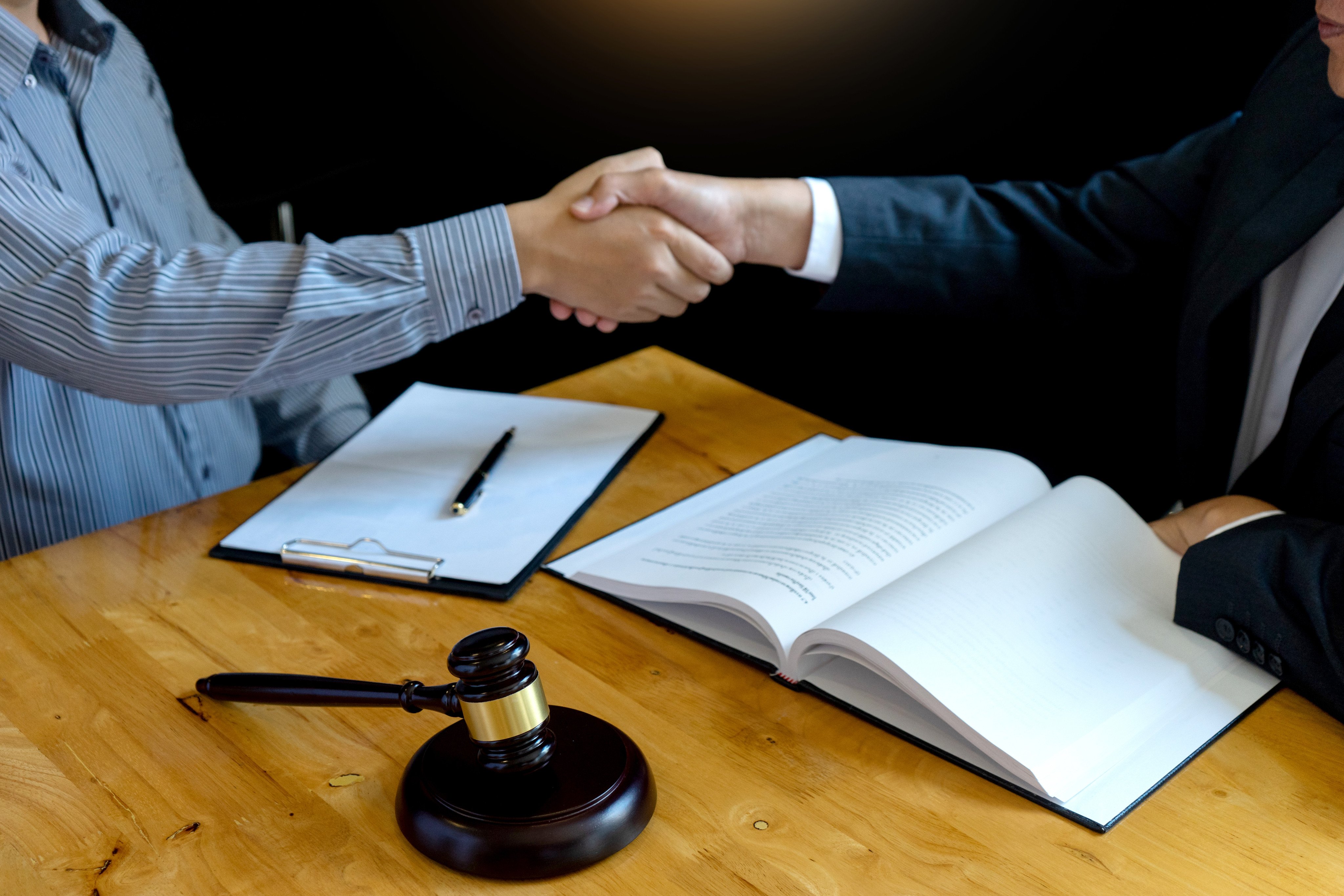 A lawyer shakes hands with client. Photo: Shutterstock