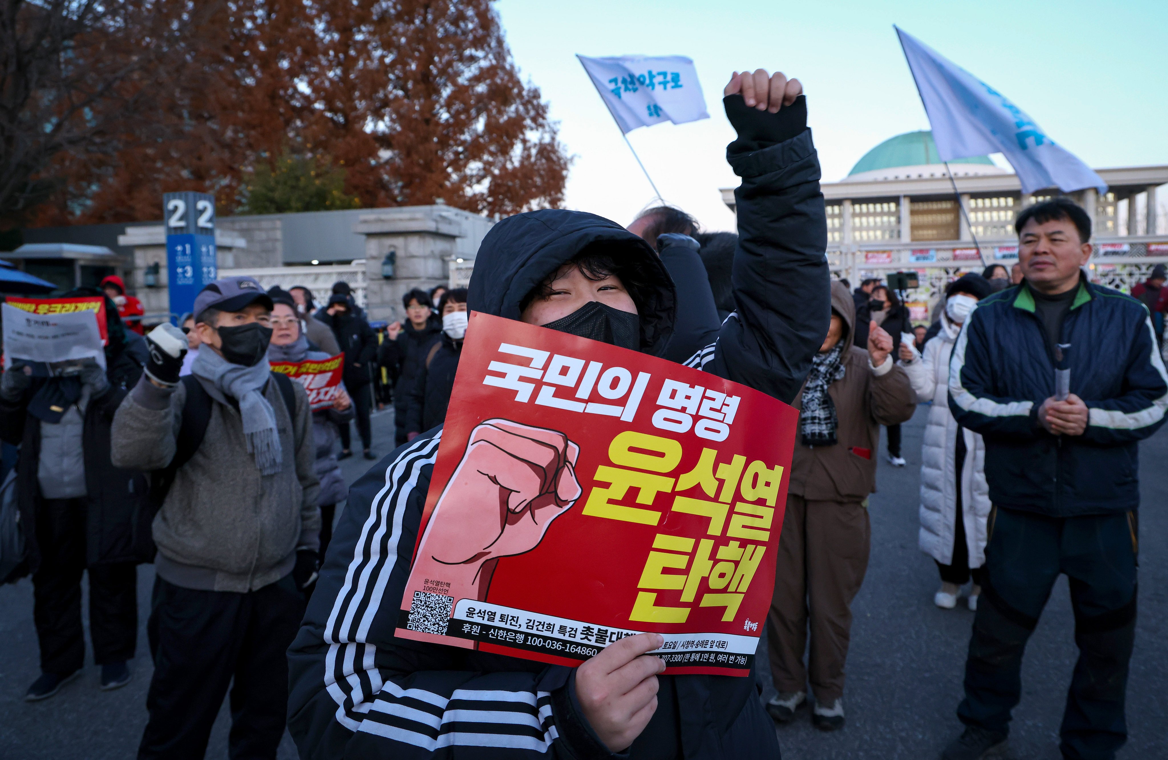 A protester calls for the impeachment and resignation of South Korean President Yoon Suk-yeol outside the National Assembly in Seoul on Wednesday morning after martial law was imposed and withdrawn within hours overnight. Photo: EPA