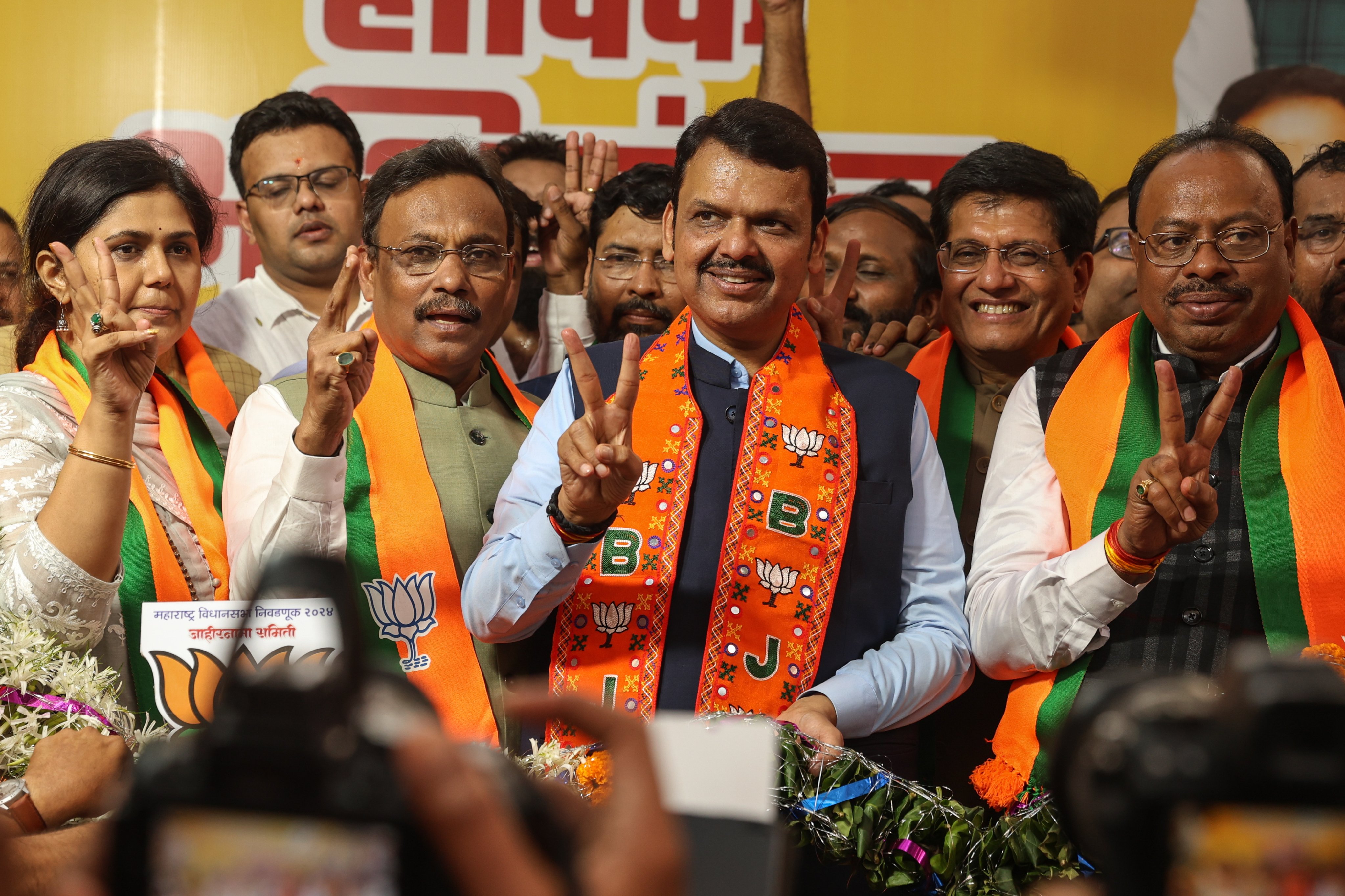 Maharashtra’s chief minister contender and Bharatiya Janta Party (BJP) leader Devendra Fadnavis (C) shows a victory sign after winning a majority in the Maharashtra state assembly elections, at the BJP head office in Mumbai, India, on November 23. Photo: EPA-EFE