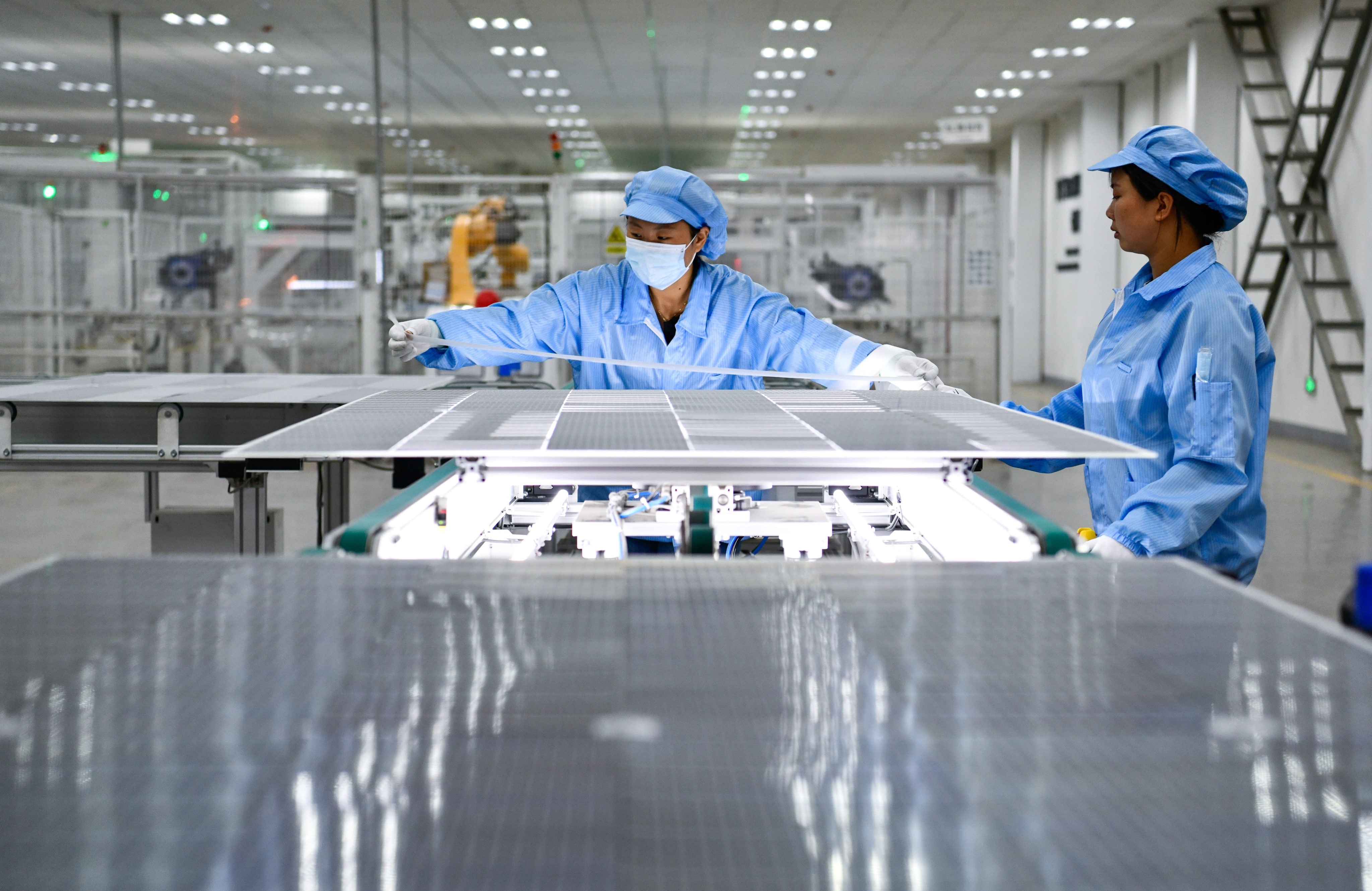 Workers produce solar photovoltaic modules at a factory in Weining, Guizhou province, on July 19, 2023. Photo: Xinhua