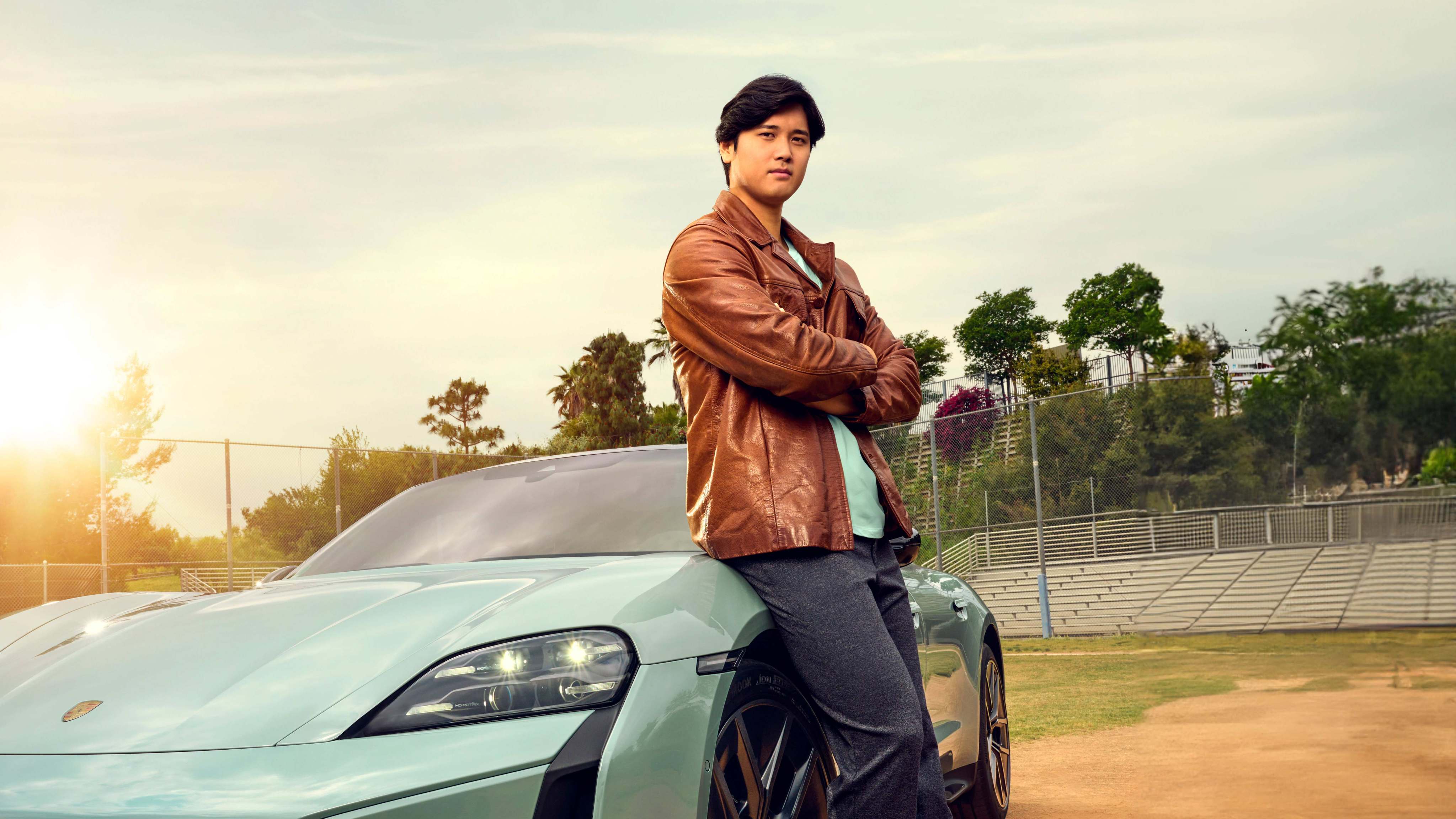 Shohei Ohtani with his 2024 Porsche Taycan Turbo S. The Japanese star had given teammate Joe Kelly a new Porsche when Kelly agreed to hand over his No 17 shirt. Photo: Porsche