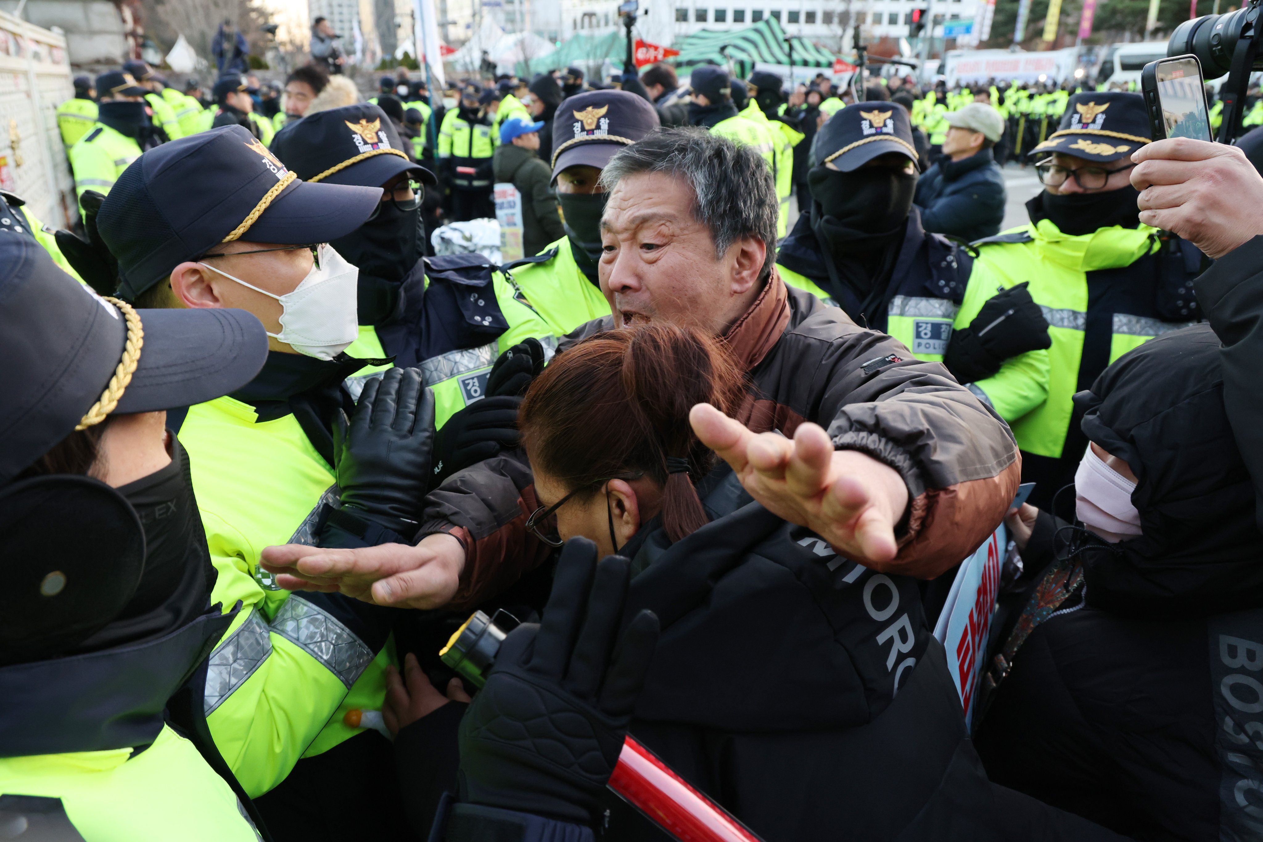 Protesters clash with police officers during a demonstration in Seoul on Wednesday calling for President Yoon Suk-yeol’s resignation and impeachment. Photo: EPA-EFE