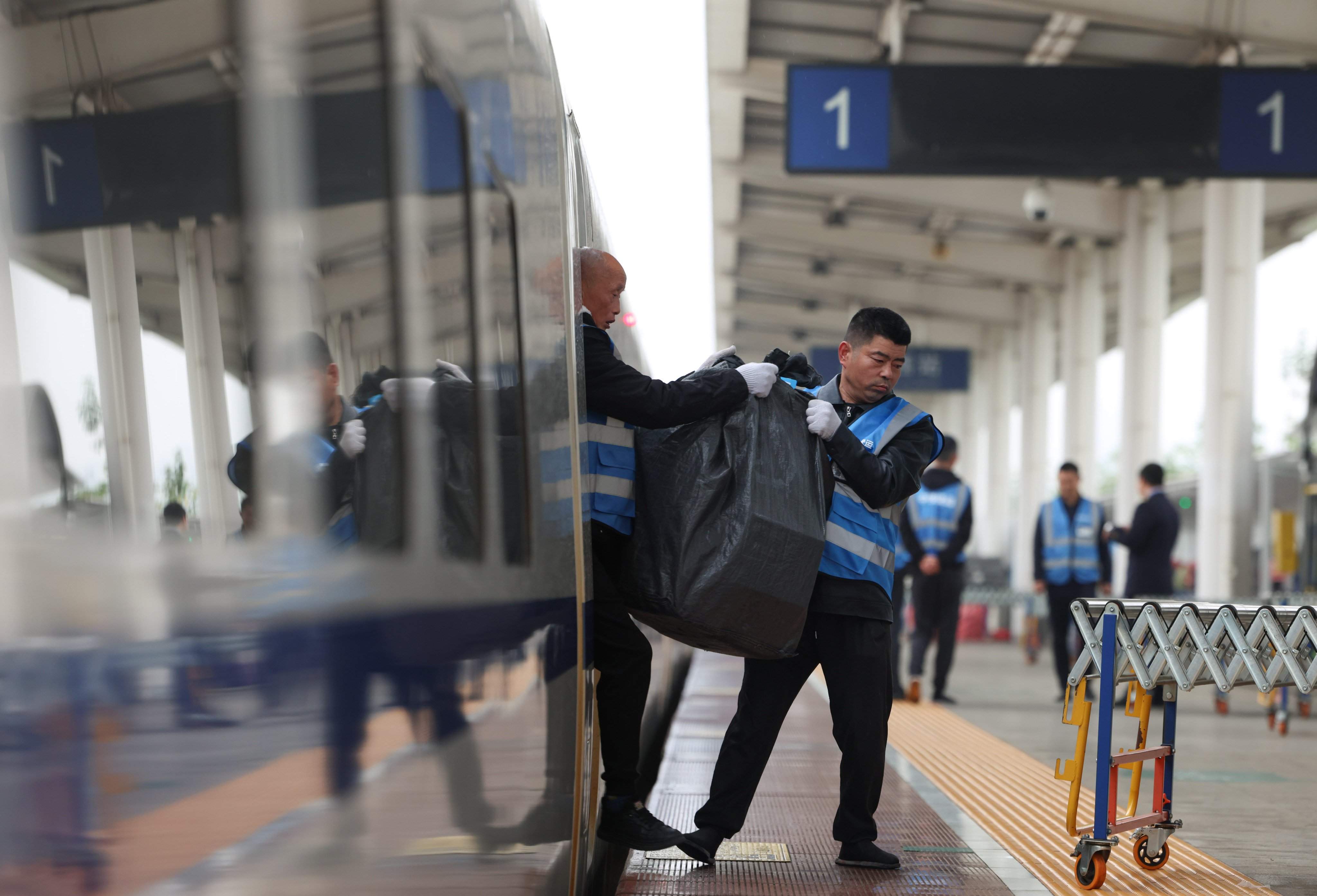 Workers unload e-commerce parcels from a bullet train at Shuangliu West Railway Station in Chengdu, southwest China’s Sichuan province. Photo: Xinhua