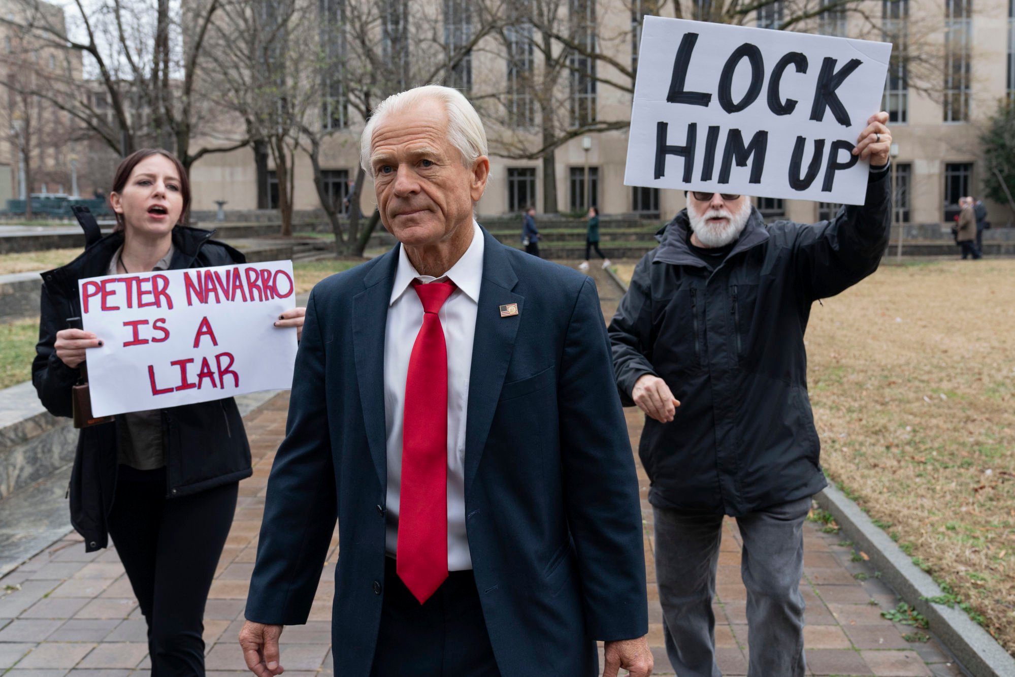 Former Trump White House official Peter Navarro is followed by demonstrators as he leaves a US federal courthouse in Washington in January. Photo: AP