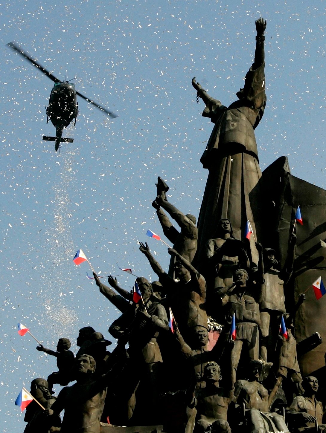 A helicopter releases confetti over the People Power monument during the 21st anniversary celebration of the 1986 People Power Revolution in Manila in 2007. Photo: Reuters