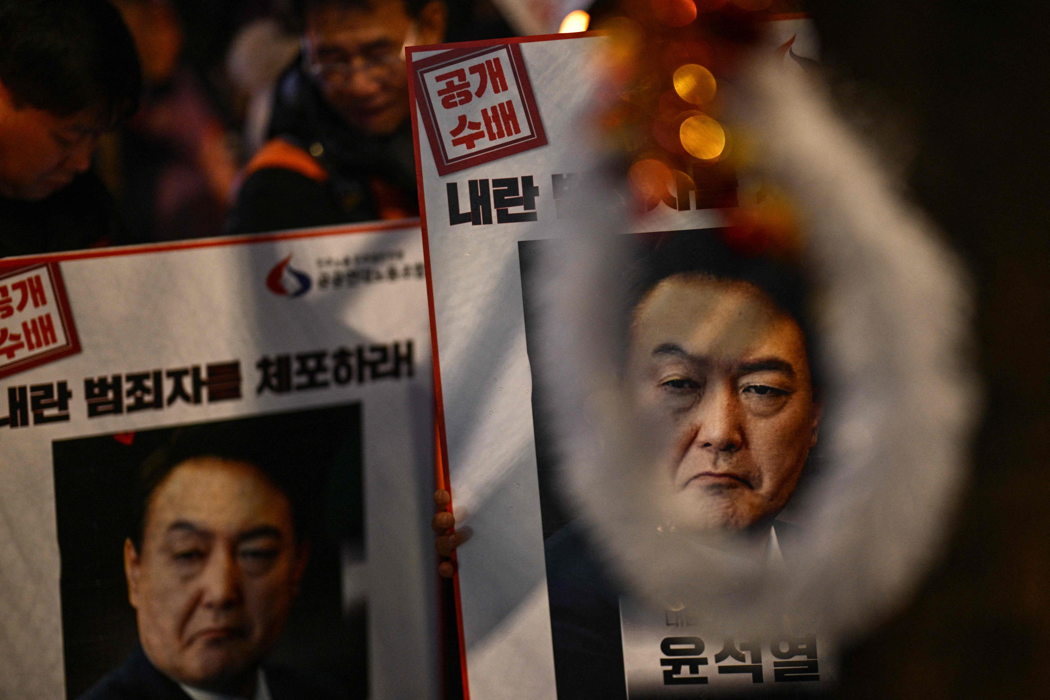 Posters with images of South Korean President Yoon Suk-yeol at a rally calling for his ouster in Seoul on Thursday. Photo: AFP