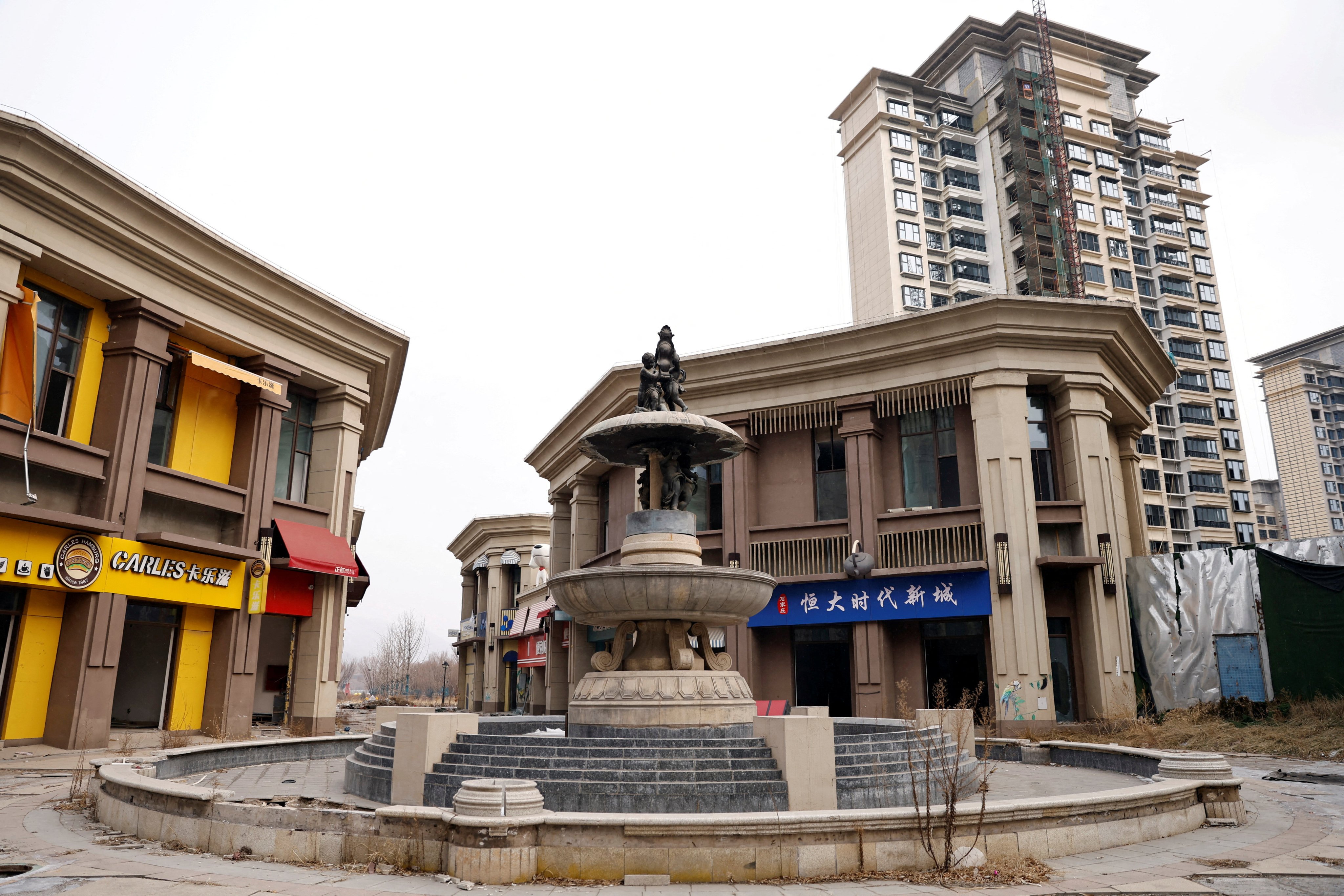 Empty shops near an unfinished residential buildings developed by China Evergrande Group in Shijiazhuang, Hebei province in February 2024. Photo: Reuters