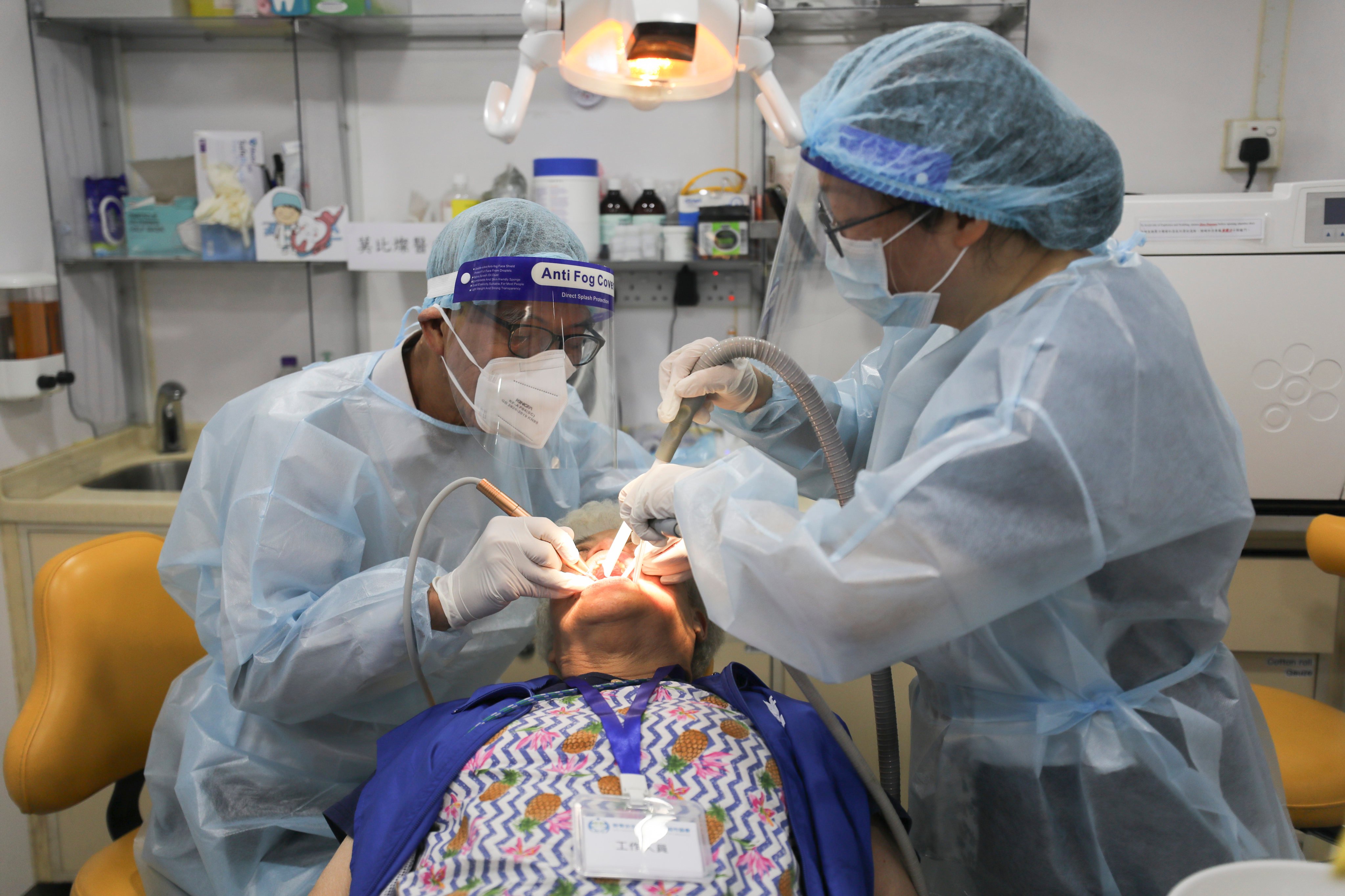 An elderly woman of Kwai Tsing is getting her teeth cleaned at a dental truck in Lai King. Photo: Xiaomei Chen