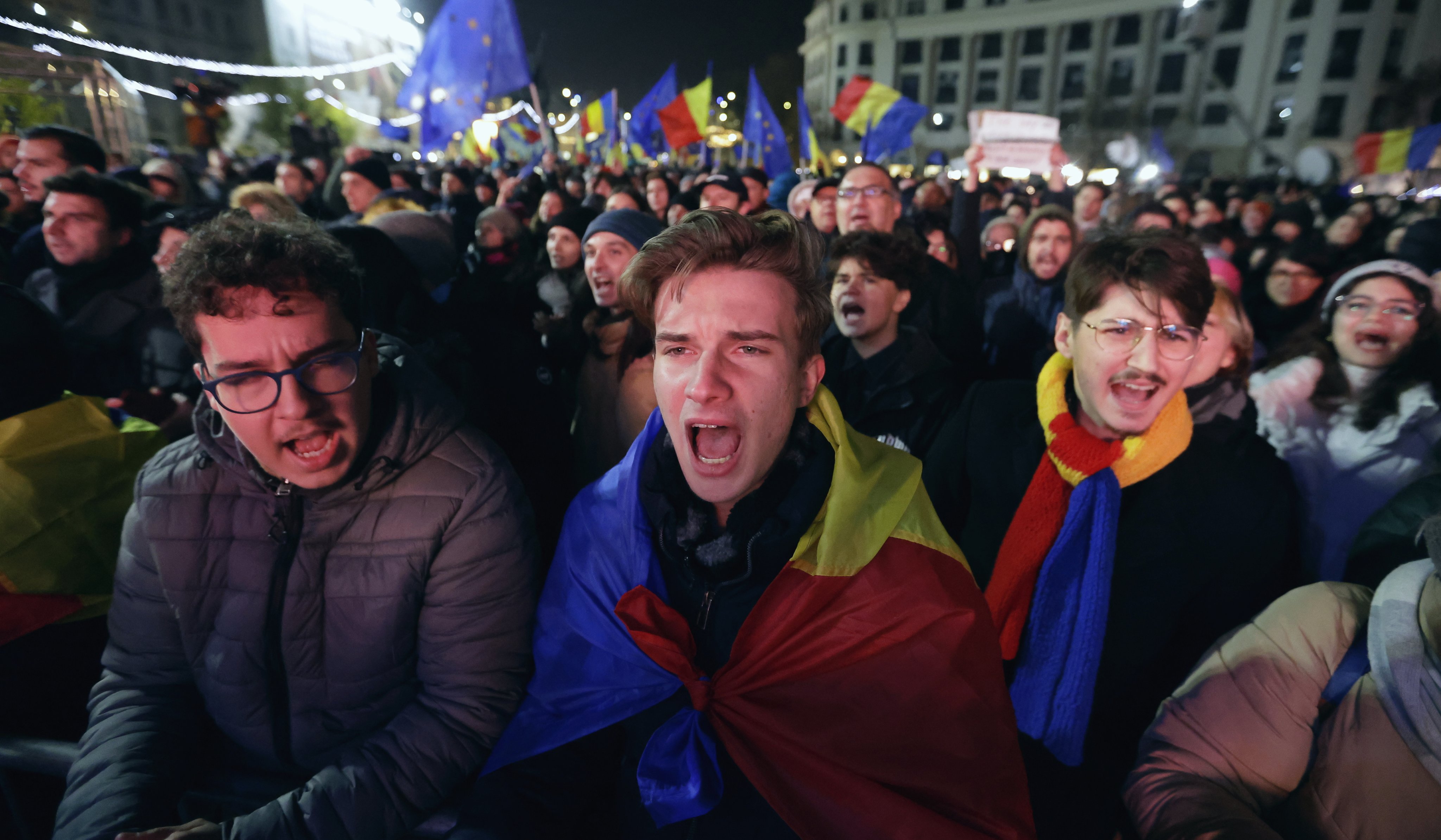 People sing while waving Romanian and European Union flags during a pro-Europe rally ahead of the runoff elections, in downtown Bucharest. Photo: EPA-EFE