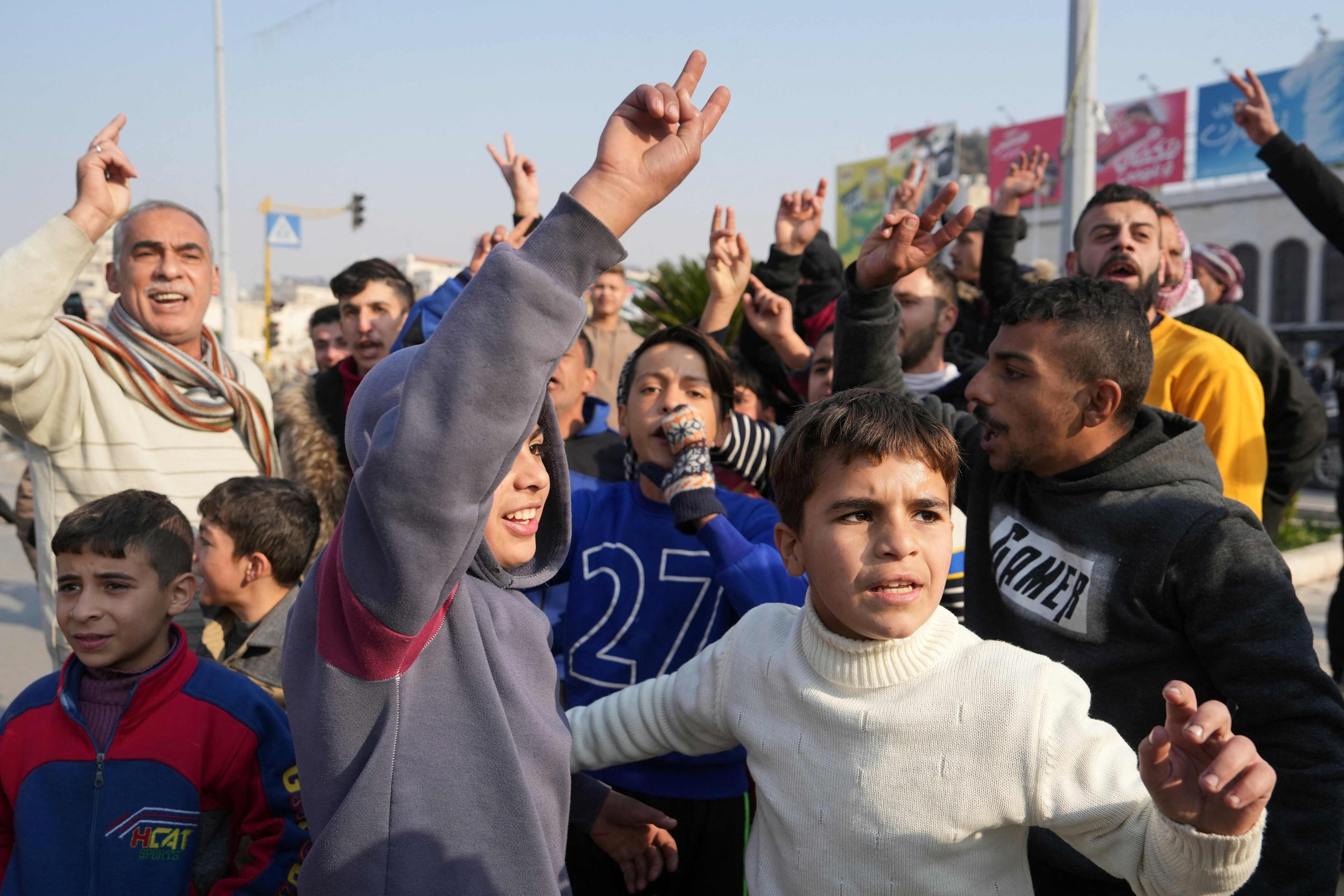 Hama residents cheer as Syrian anti government fighters enter the city. Photo: AFP