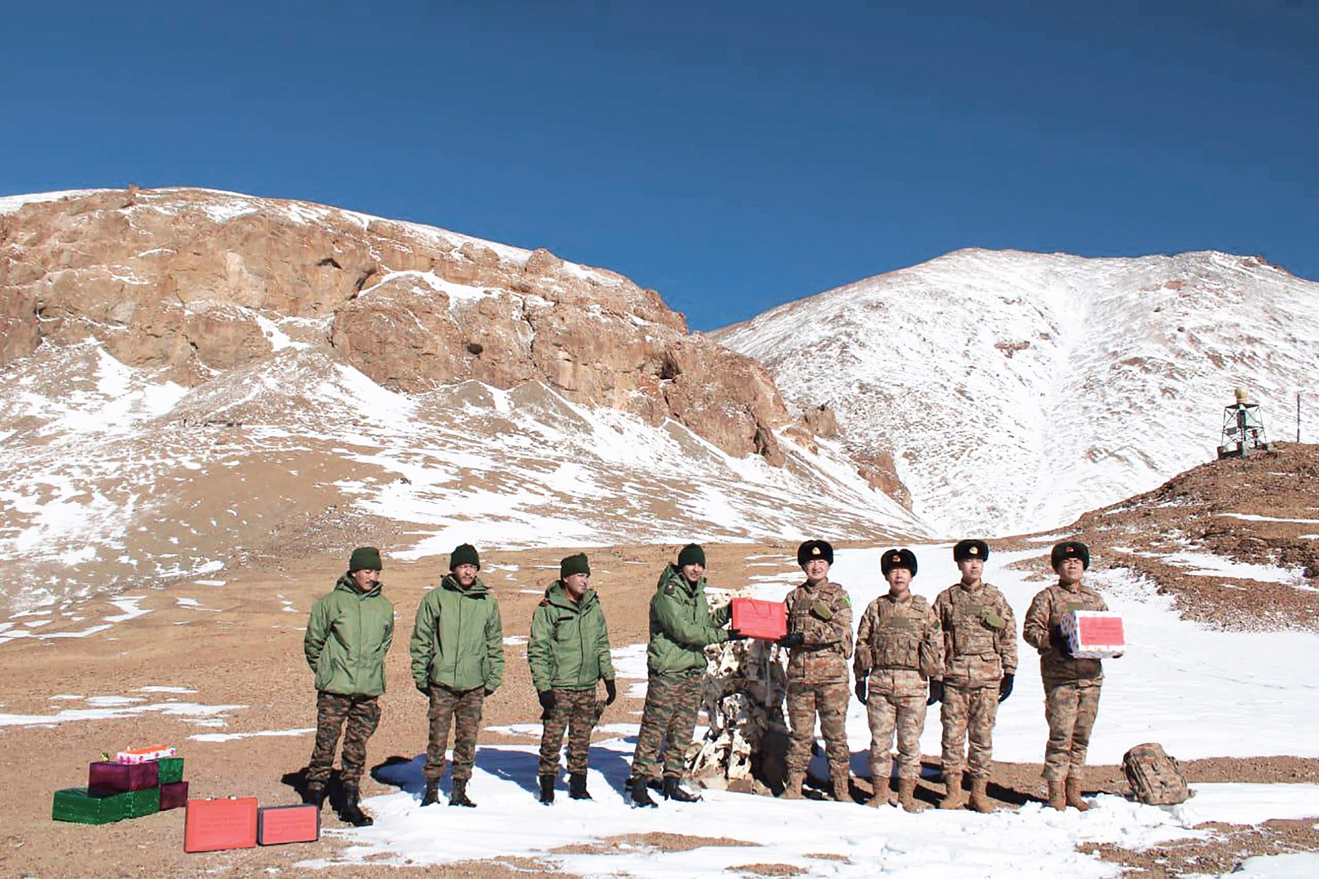 Indian and Chinese troops greet each other and exchange sweets along the Line of Actual Control in Ladakh on October 31, on the occasion of the Indian festival of Diwali. Photo: AFP 