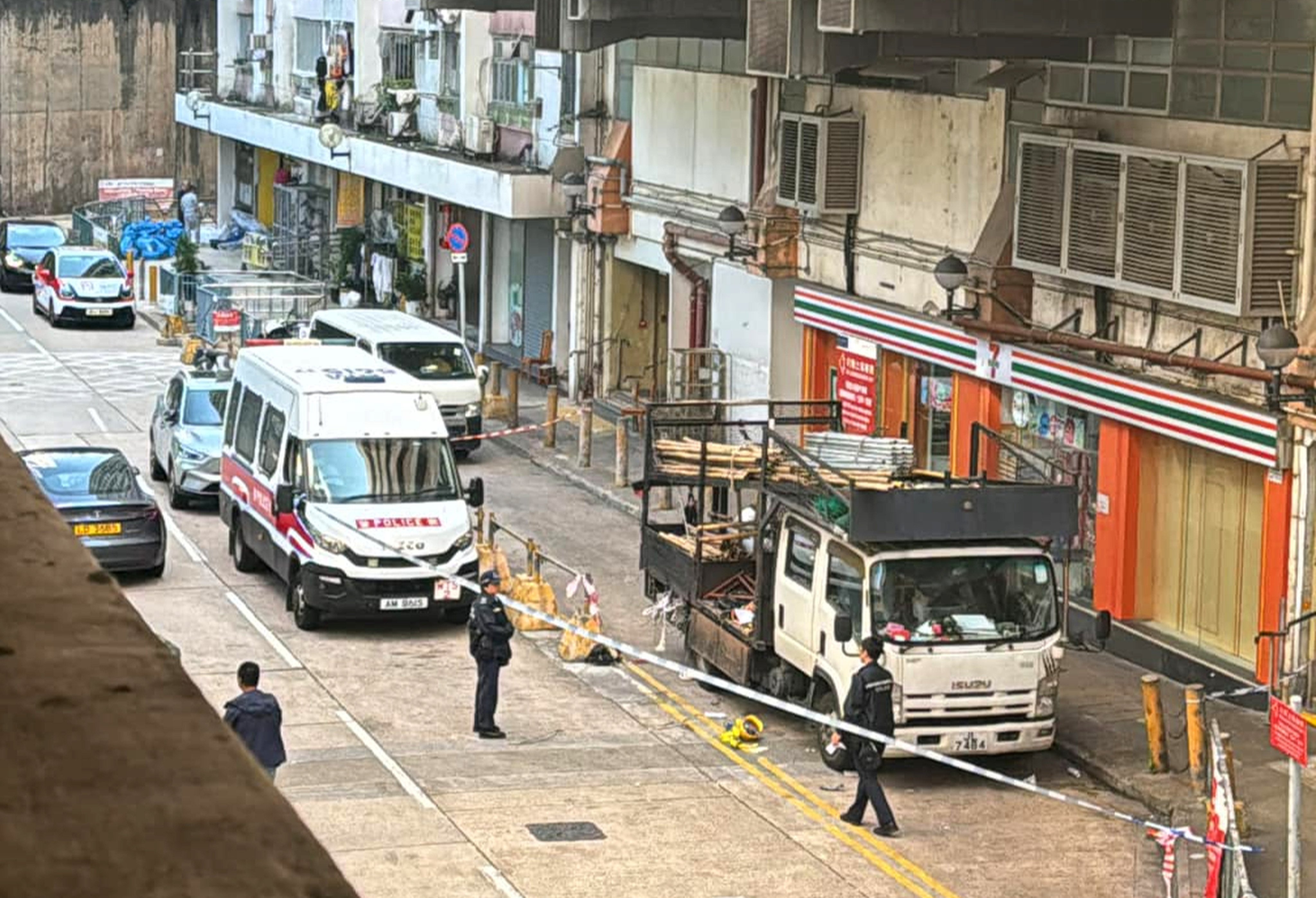 The victim landed on a truck loaded with bamboo poles after falling, police say. Photo: Facebook/Chris Wong