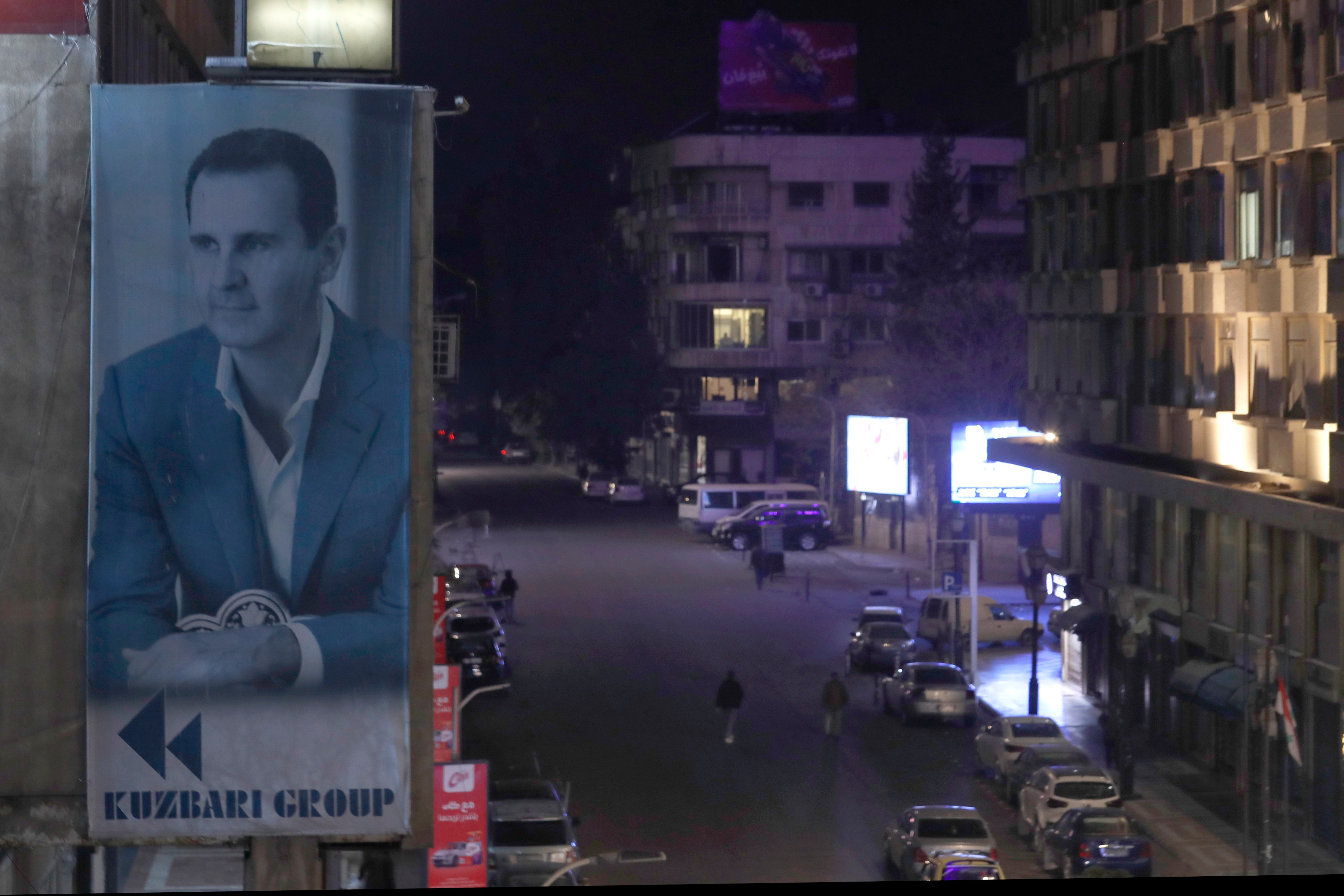A giant banner of Syrian President Bashar Assad hangs on the facade of a building in Damascus. File photo: AP