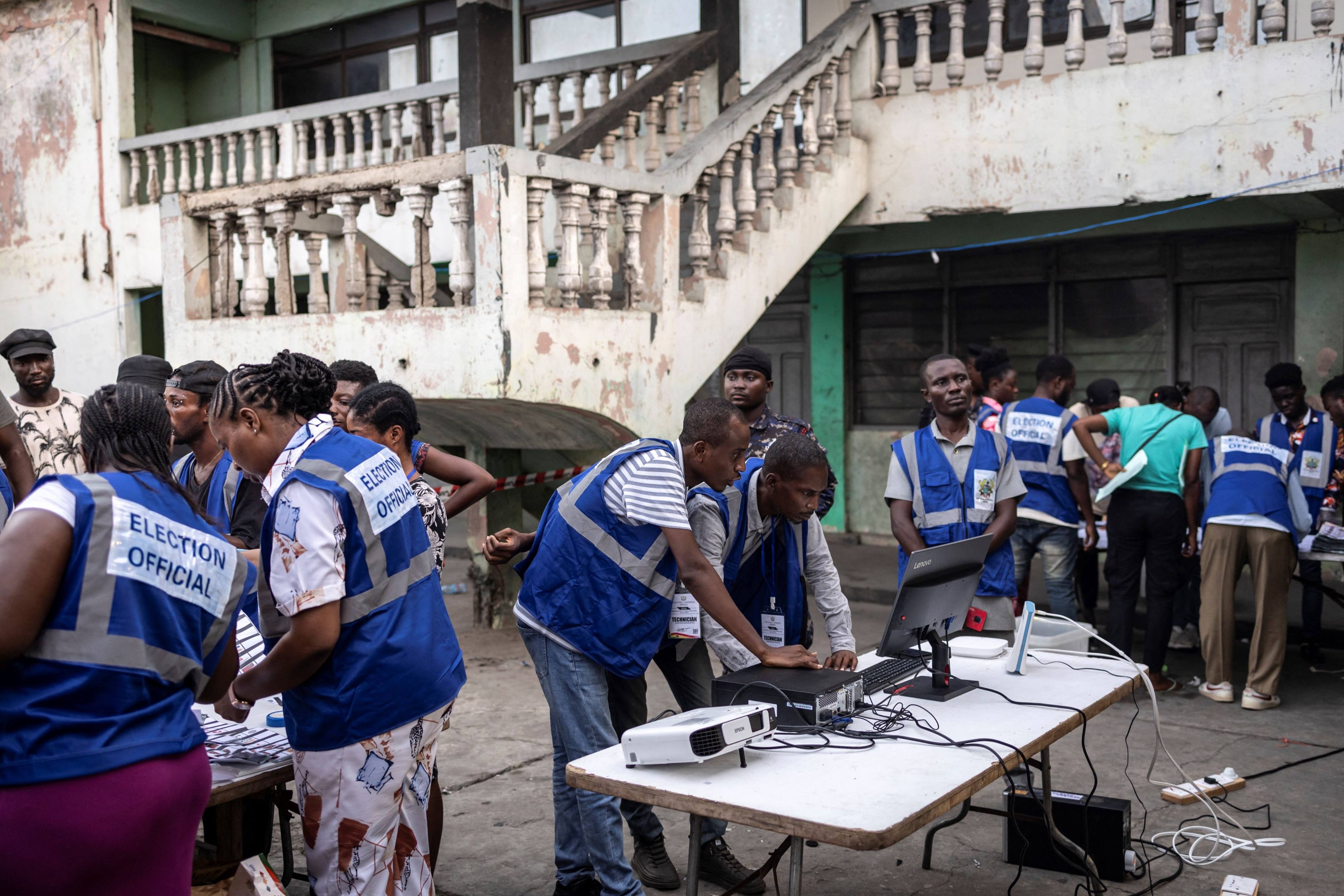 Officials from Electoral Commission Ghana count ballot papers at a polling station in Accra. Photo: AFP