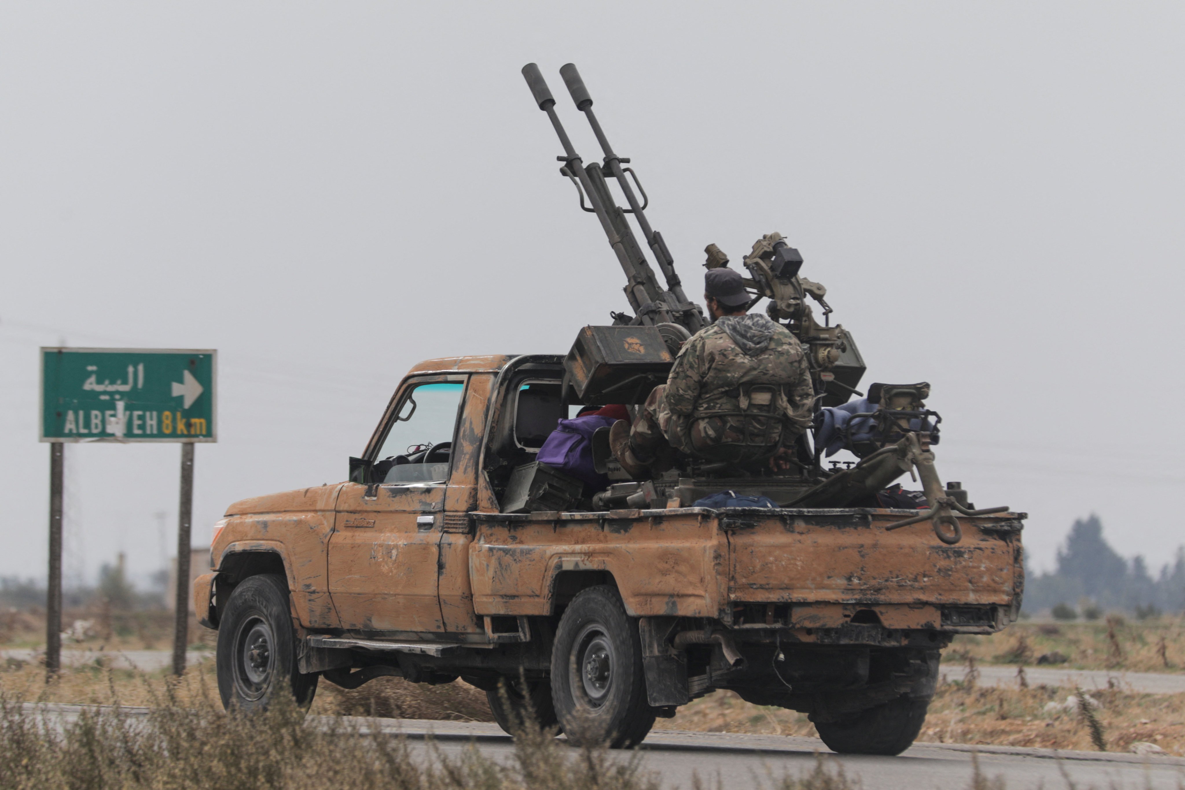 A rebel fighter sits on the back of a vehicle in the Homs countryside on Saturday. Photo: Reuters