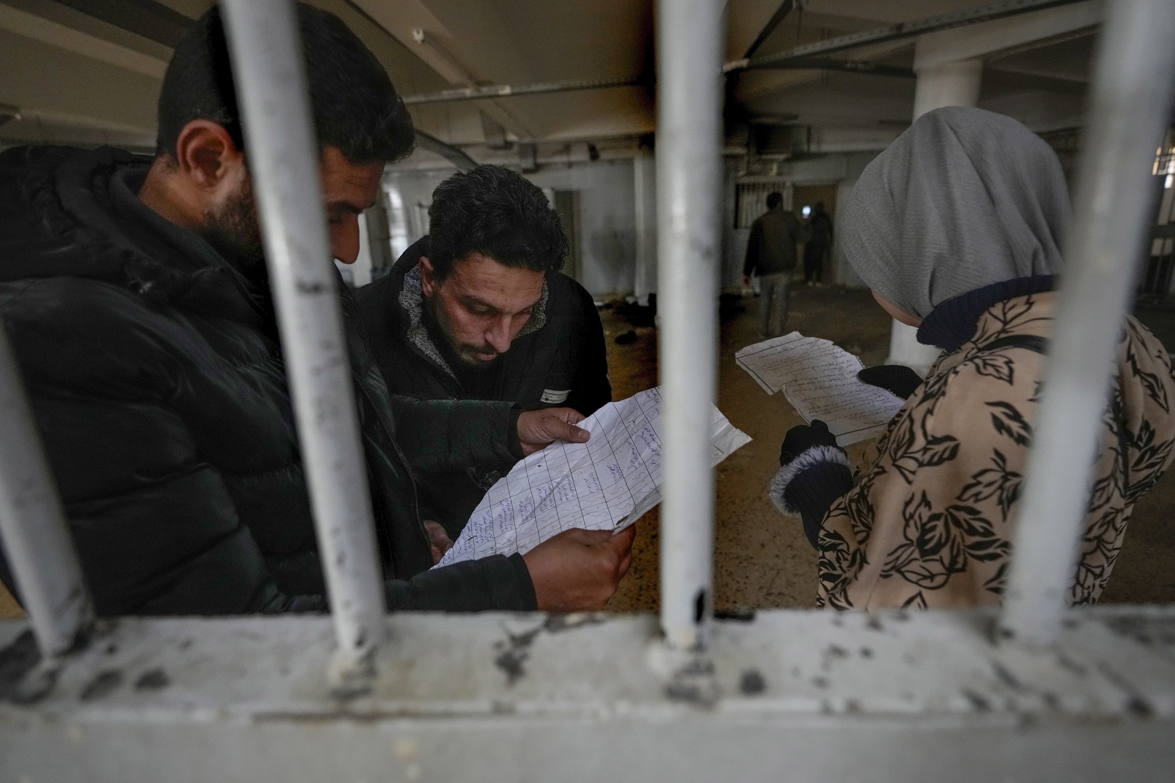 People inspecting documents they found in the infamous Saydnaya military prison, just north of Damascus, Syria, on Monday. Crowds entered the prison, known as the “human slaughterhouse,” after thousands of inmates were released following the rebels’ overthrow of Bashar al-Assad’s regime on Sunday. Photo: AP