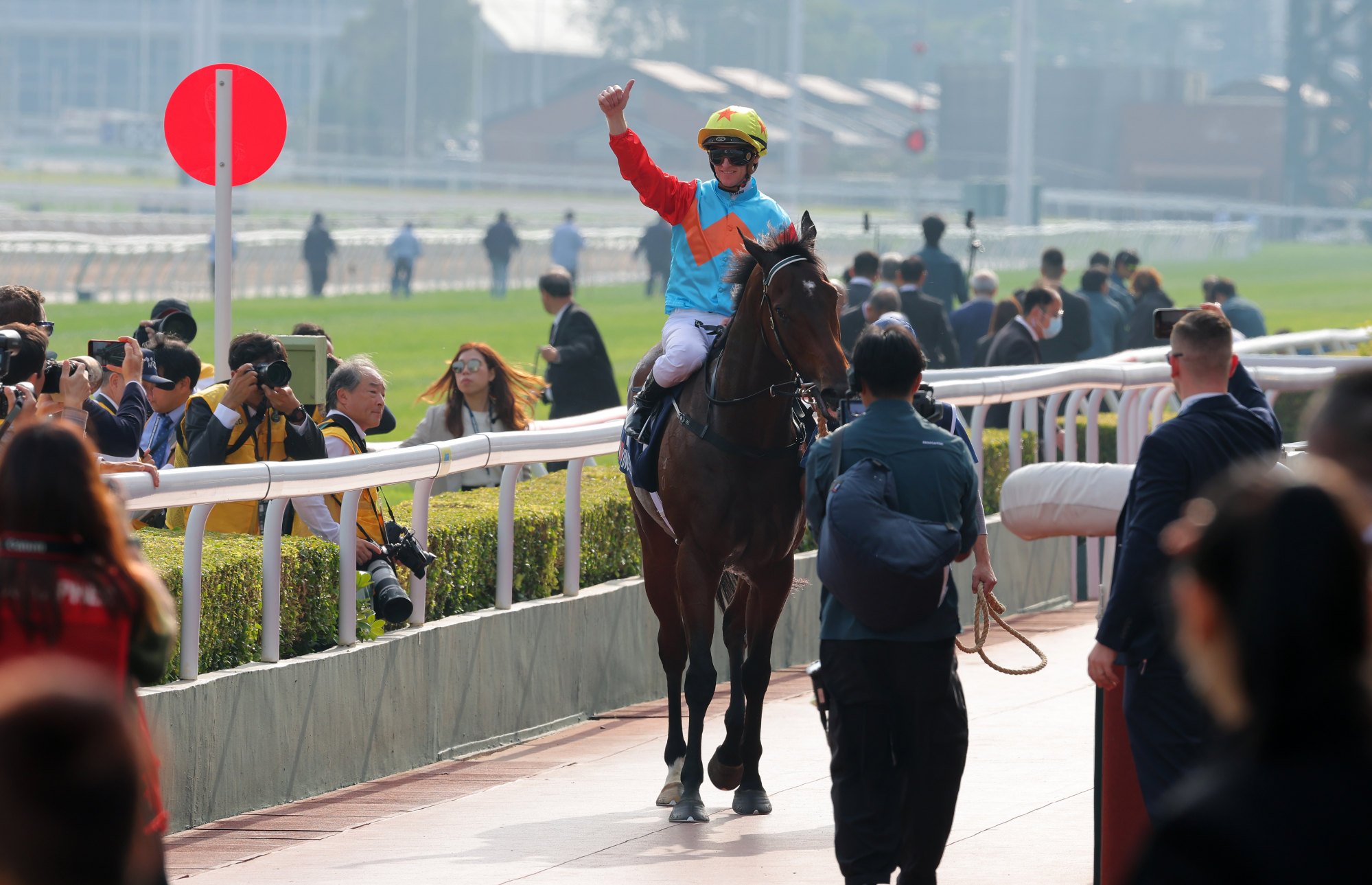 Zac Purton greets the crowd after saluting aboard Ka Ying Rising.