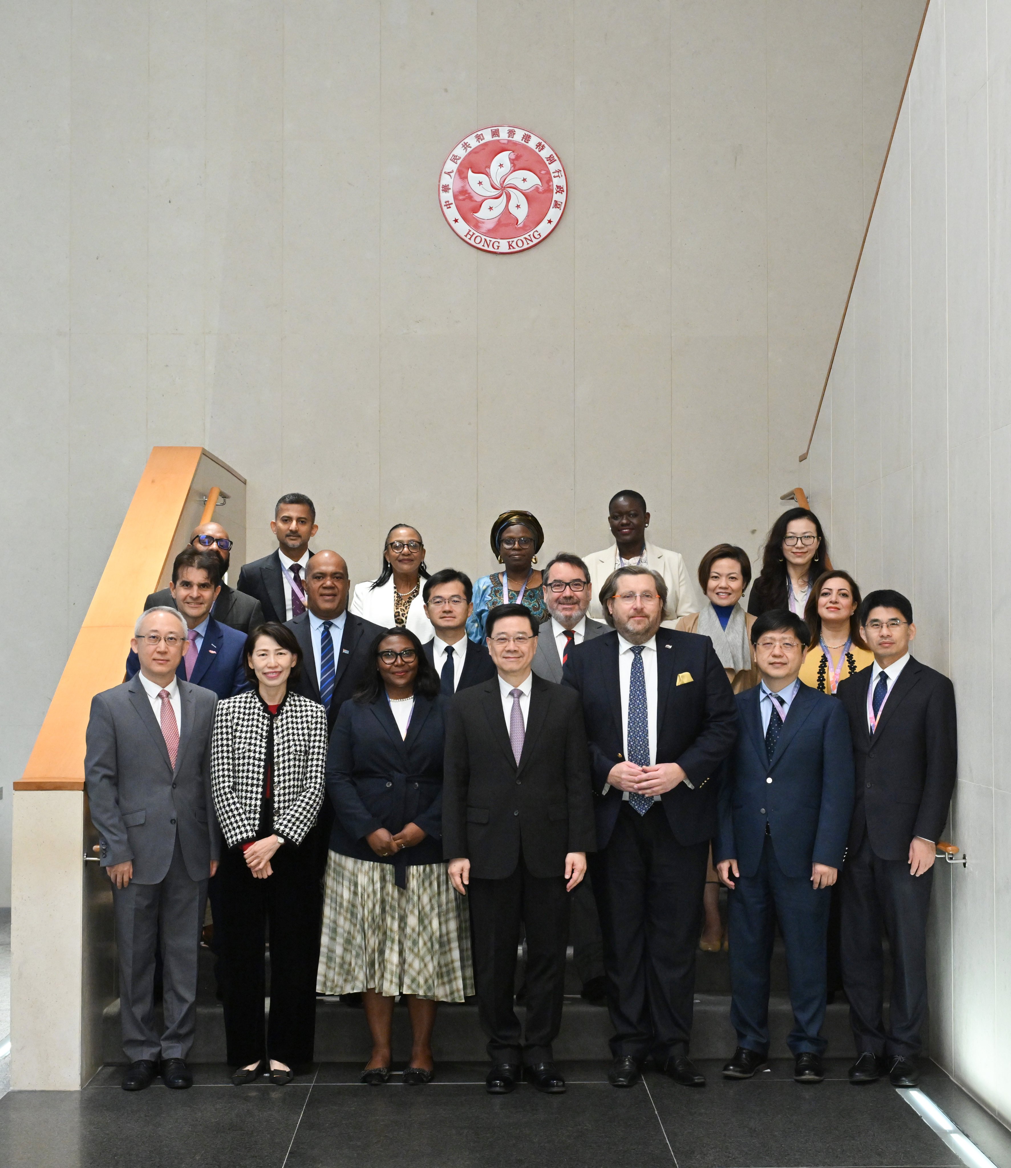 Hong Kong leader John Lee (first row, centre), meets members of a visiting delegation of overseas government officials. Photo: ISD