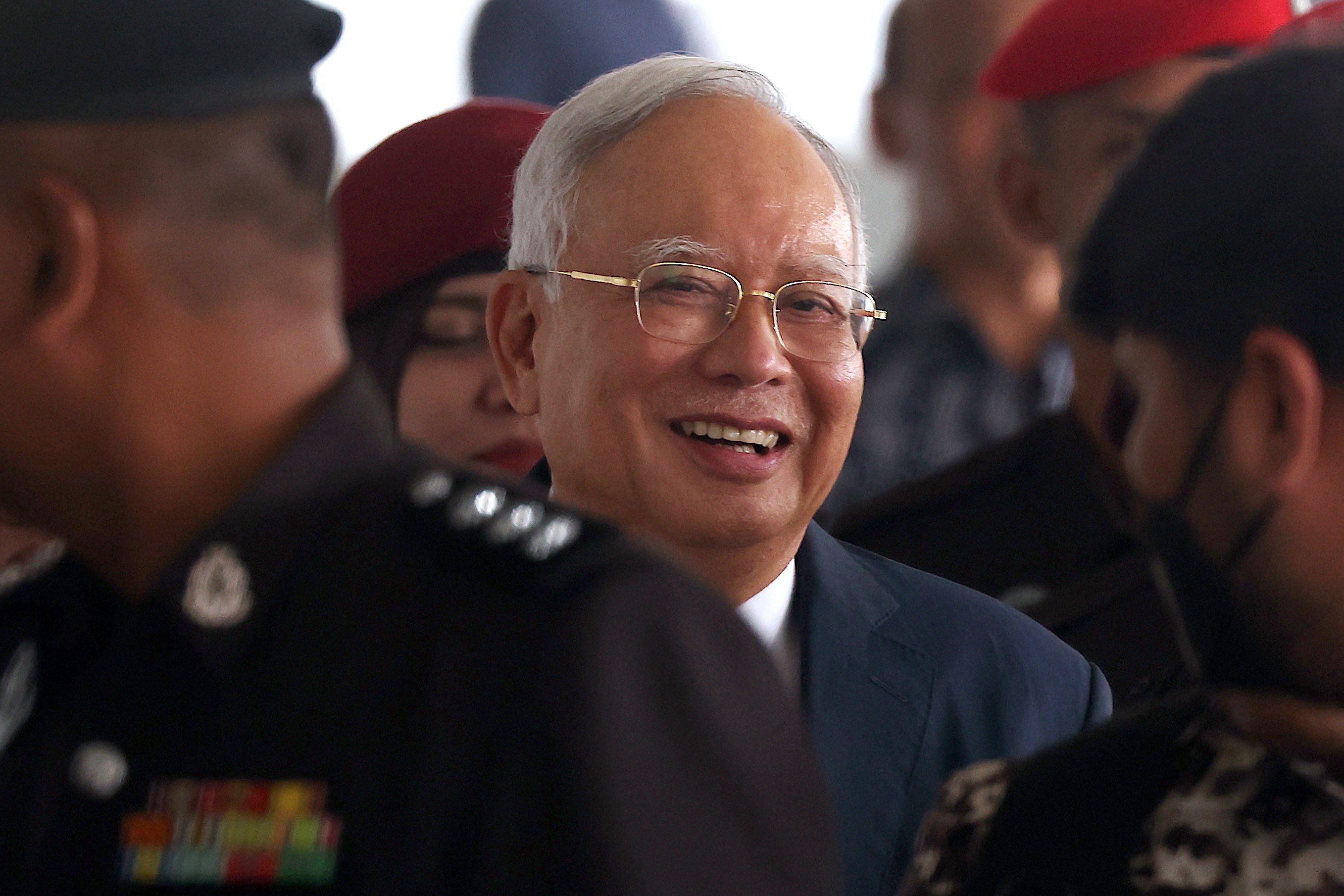 Malaysia’s former Prime Minister Najib Razak is escorted by police officers at Kuala Lumpur High Court in April. Photo: EPA-EFE