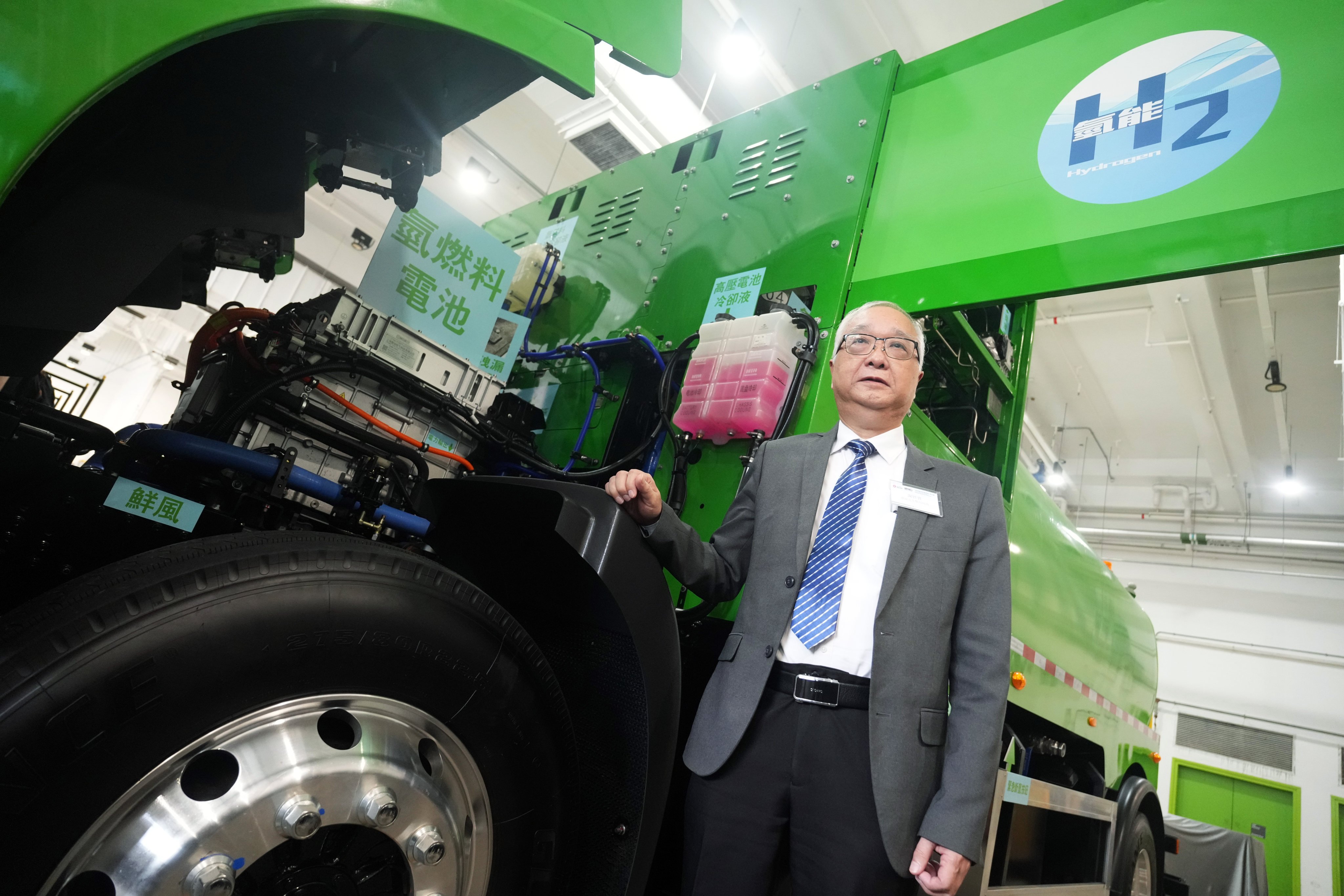 Secretary for Environment and Ecology Tse Chin-wan next to a hydrogen-powered street-washing vehicle. Photo: SCMP / Sam Tsang