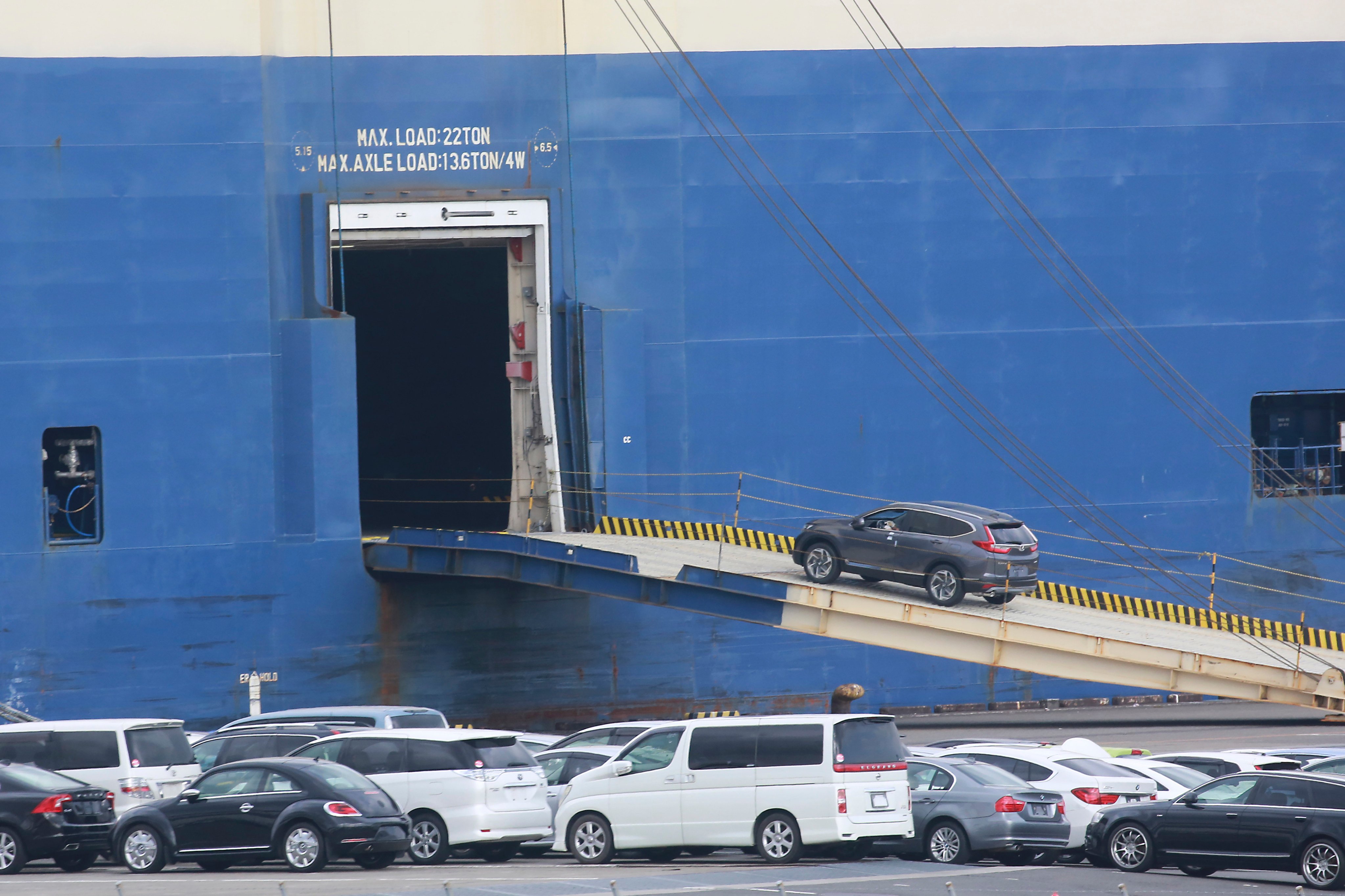 Cars for export are loaded onto a cargo ship at a port in Yokohama. Japanese exporters are working on tactics to limit the impact of Donald Trump’s “America first” policy. Photo: AP