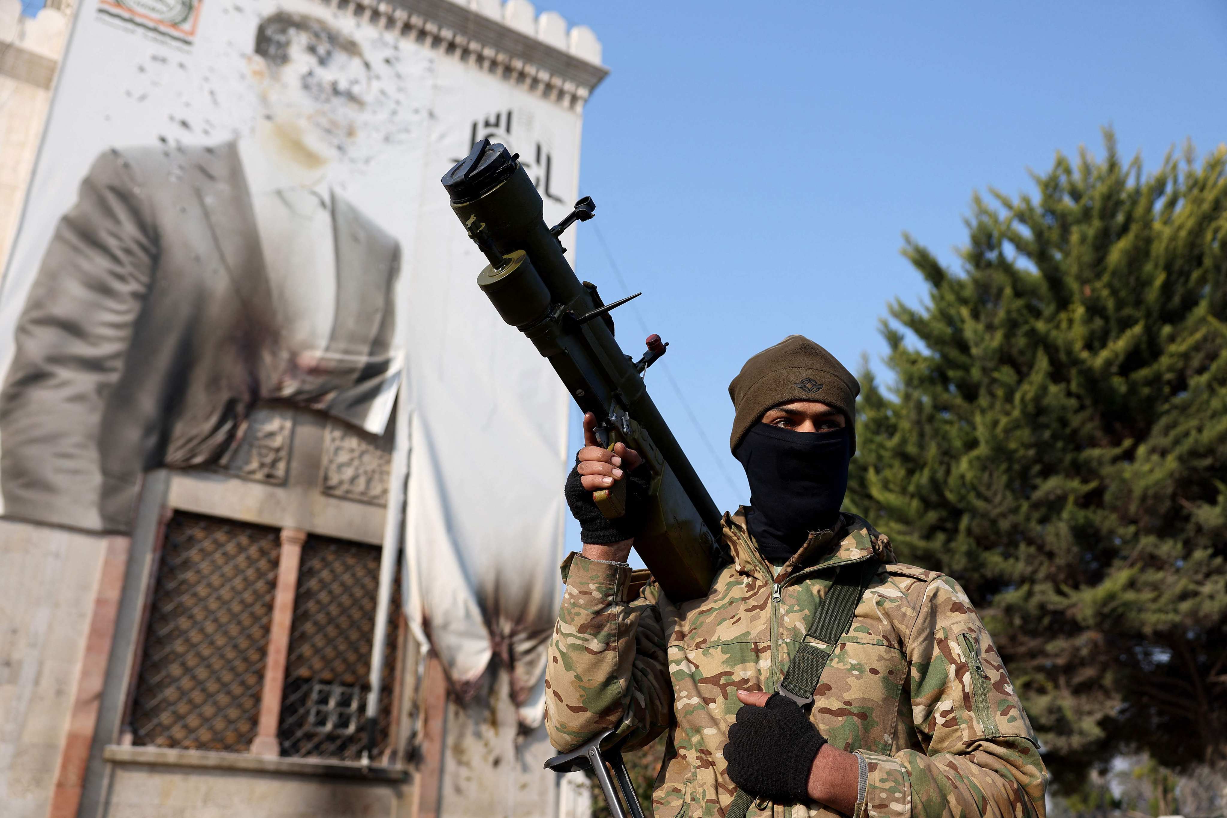  An anti-government near a defaced portrait of Syria’s Bashar al-Assad, in the city of Hama. Photo: AFP