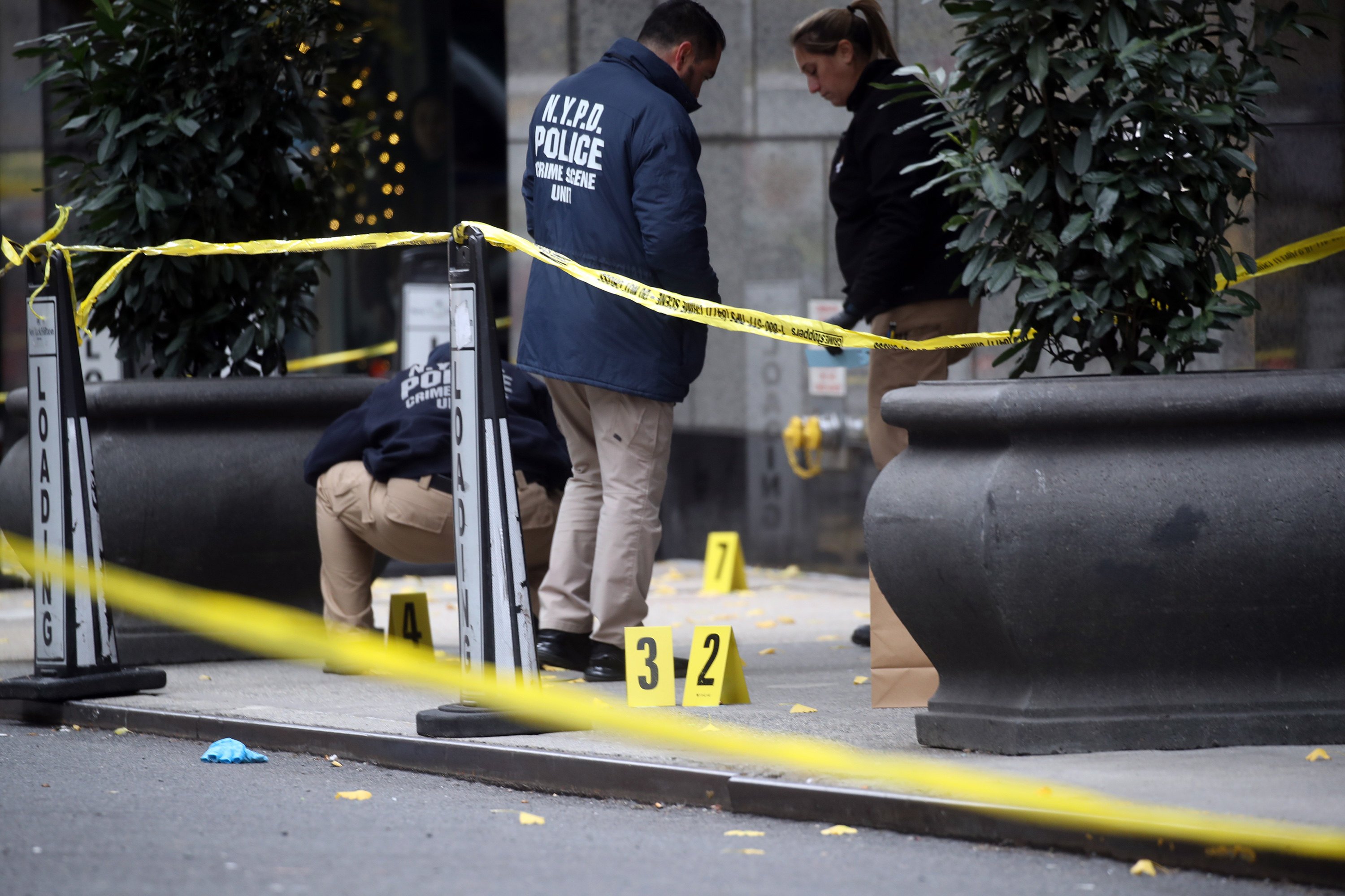 Police place bullet casing markers outside of a Hilton Hotel in midtown Manhattan, where UnitedHealthcare CEO Brian Thompson was fatally shot on Wednesday. Photo: Getty Images/TNS