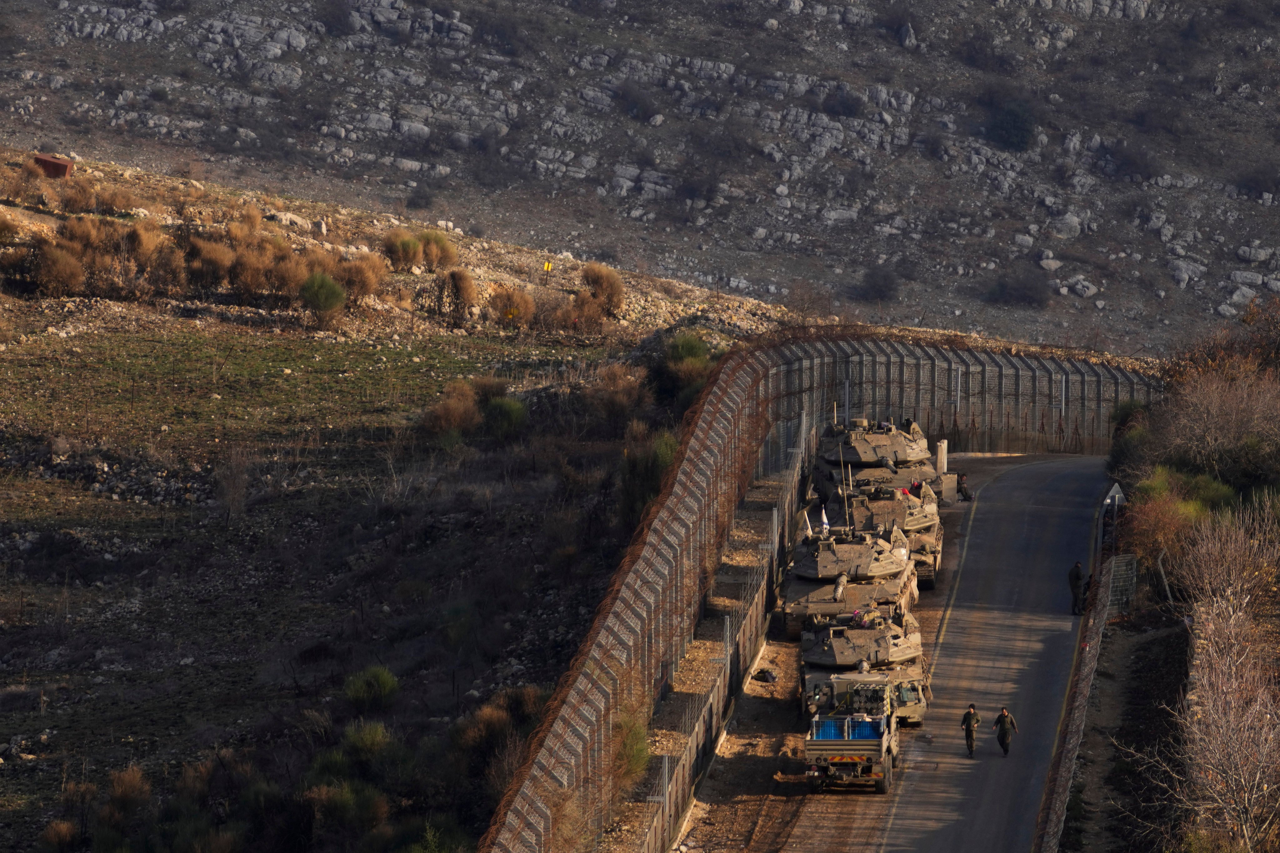 Israeli soldiers near armoured vehicles parked along the so-called Alpha Line that separates the Israeli-annexed Golan Heights from Syria. Photo: AP