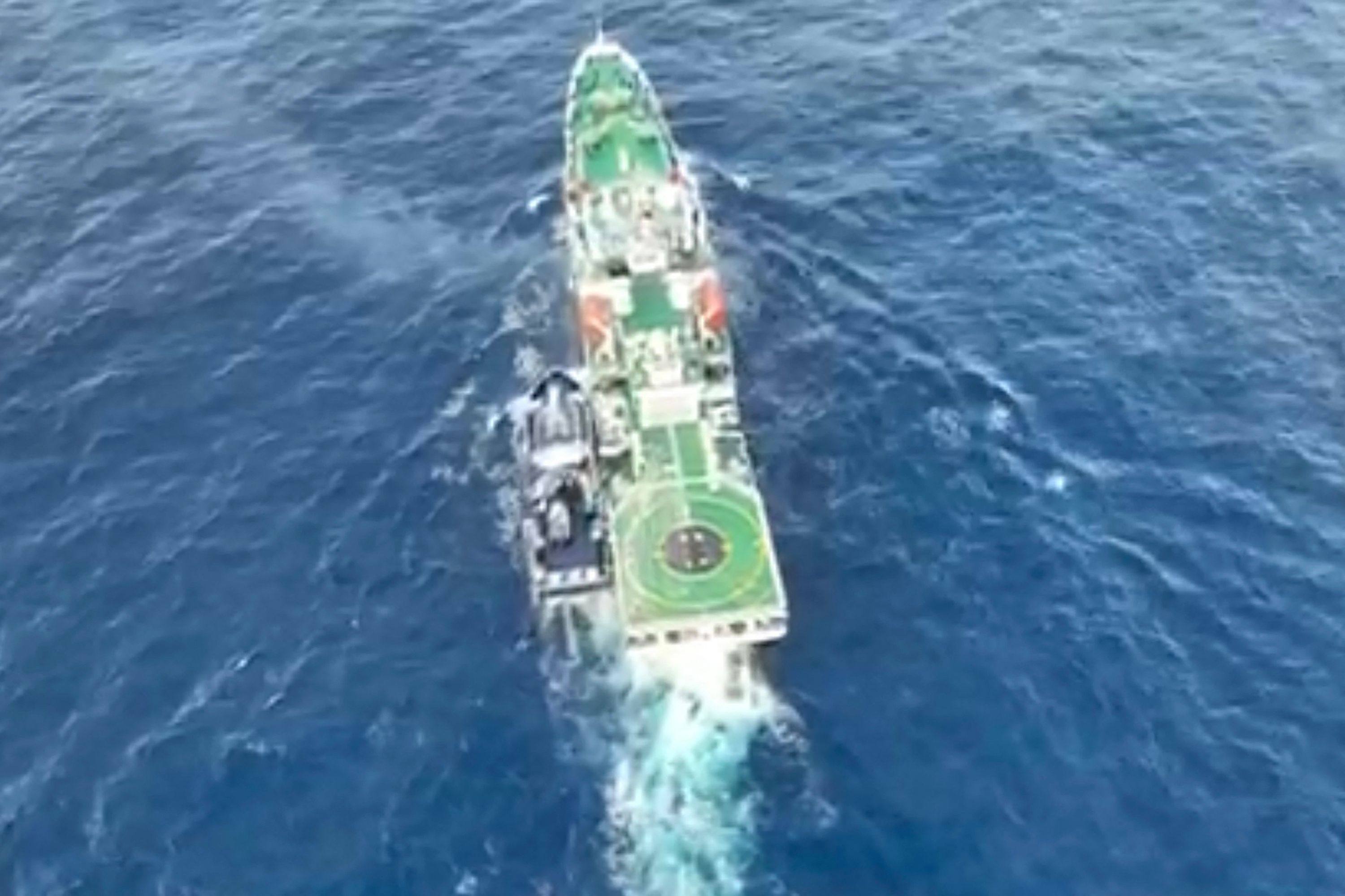 A China Coast Guard ship (right) with the Philippine vessel BRP Datu Pagbuaya (left) near Scarborough Shoal in disputed waters of the South China Sea on December 4. Photo: Handout / National Task Force for the West Philippine Sea / AFP