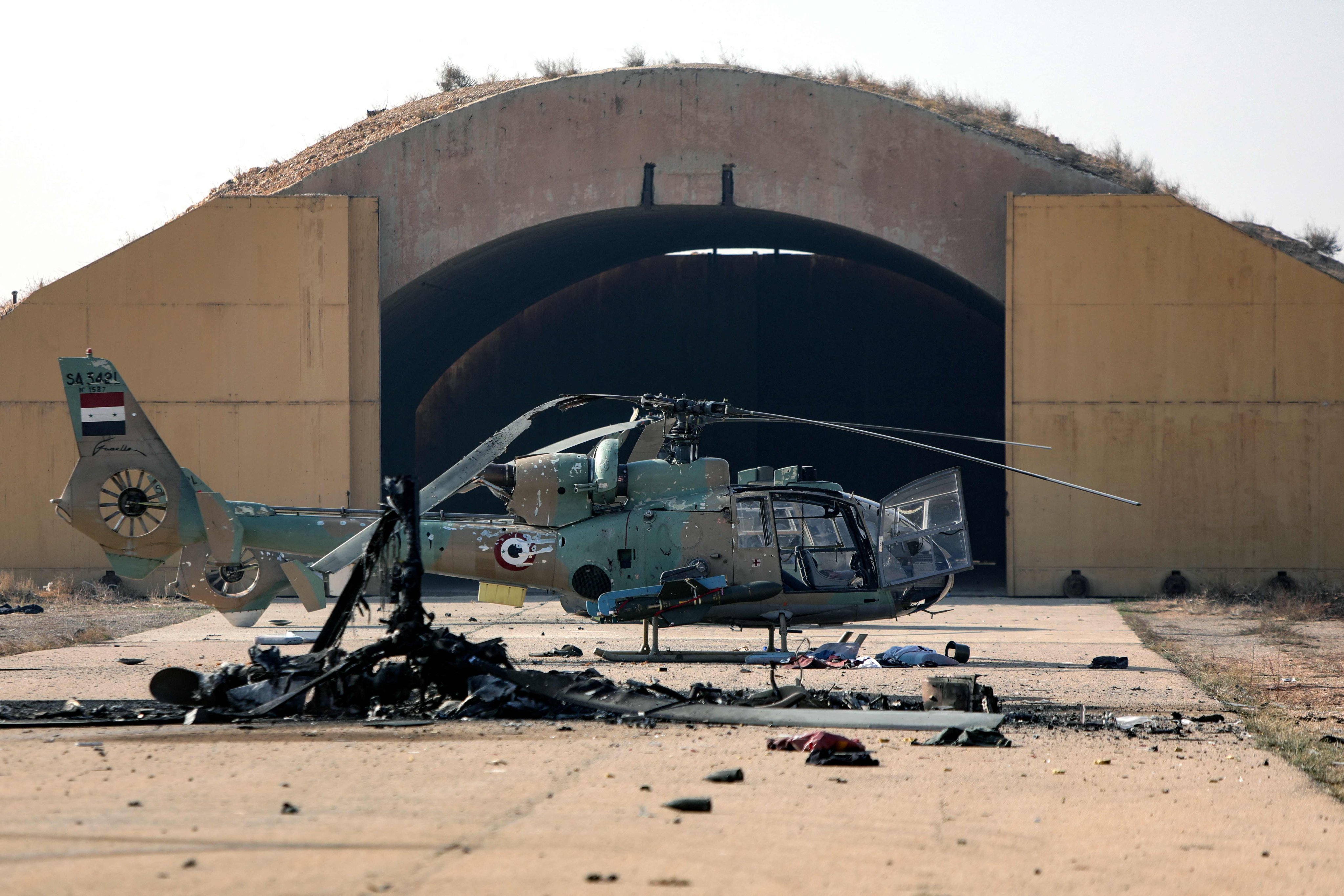 A burned Syrian army helicopter after the Israeli military hit weapons facilities outside Damascus. Photo: AFP