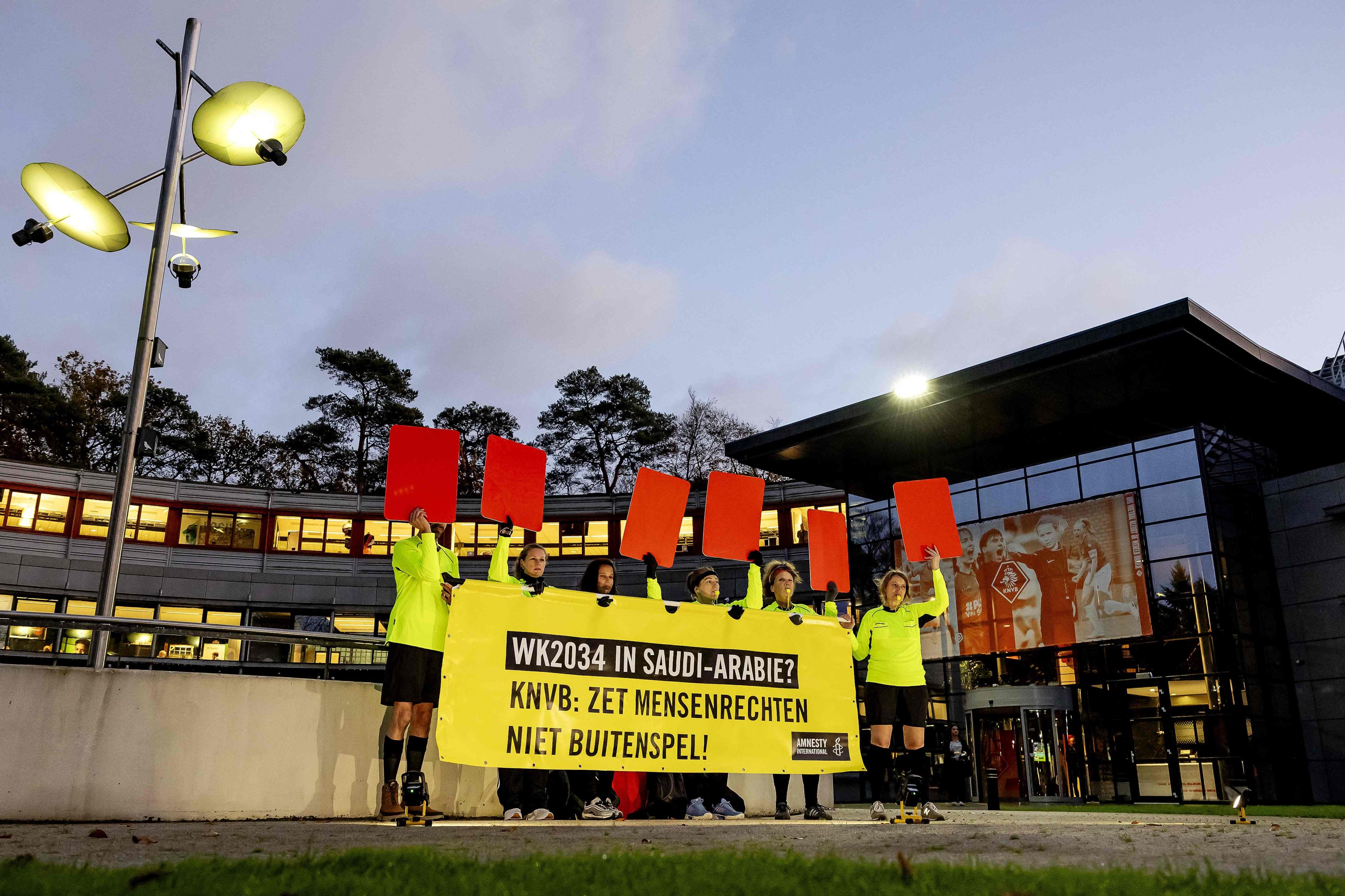 Amnesty International activists dressed as football referees holding red cards and a banner protesting against Saudi Arabia’s candidacy for the 2034 World Cup, in Zeist, Netherlands last month. Photo: AFP