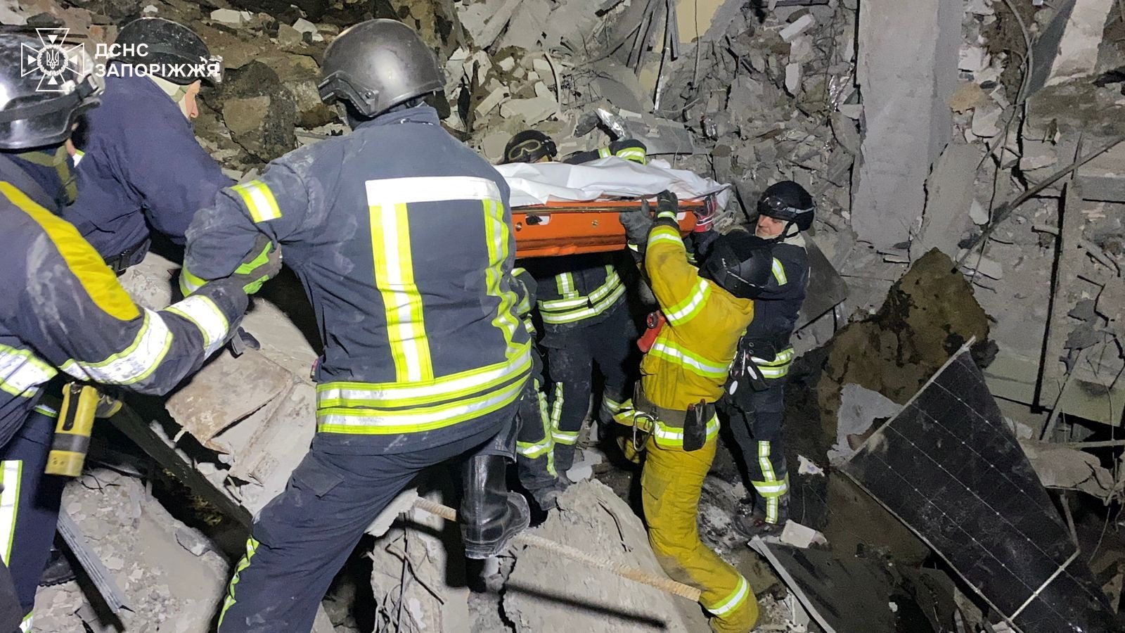 Rescuers carry the body of a person pulled from the rubble of a building that was hit by a Russian missile strike in Zaporizhzhia, Ukraine, on Tuesday. Photo: Press service of the State Emergency Service of Ukraine in Zaporizhzhia region/Handout via Reuters