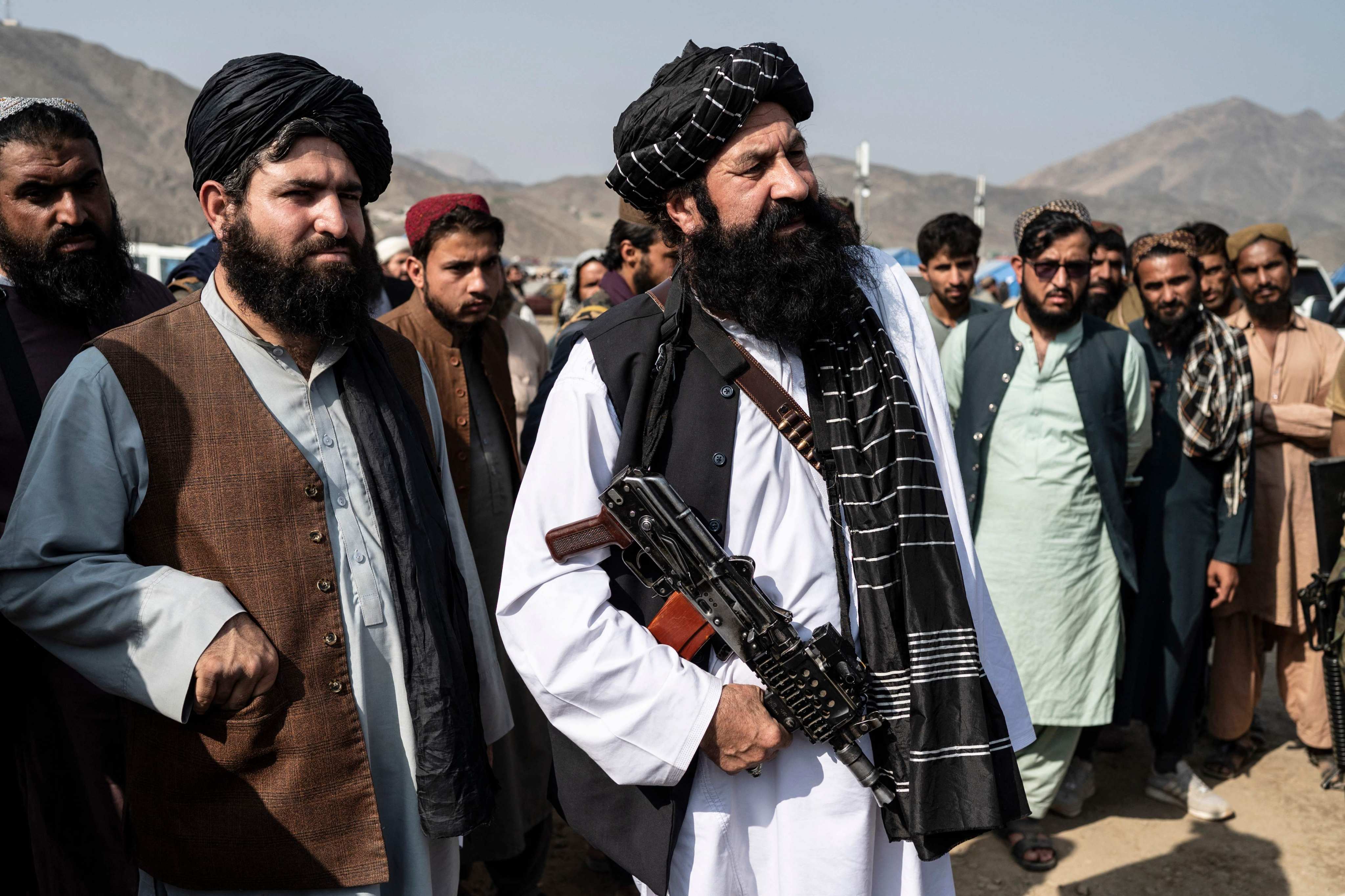 Afghanistan’s Minister for Refugees Khalil Haqqani (middle) at a refugee camp near the Afghanistan-Pakistan Torkham border in 2023. Photo: AFP